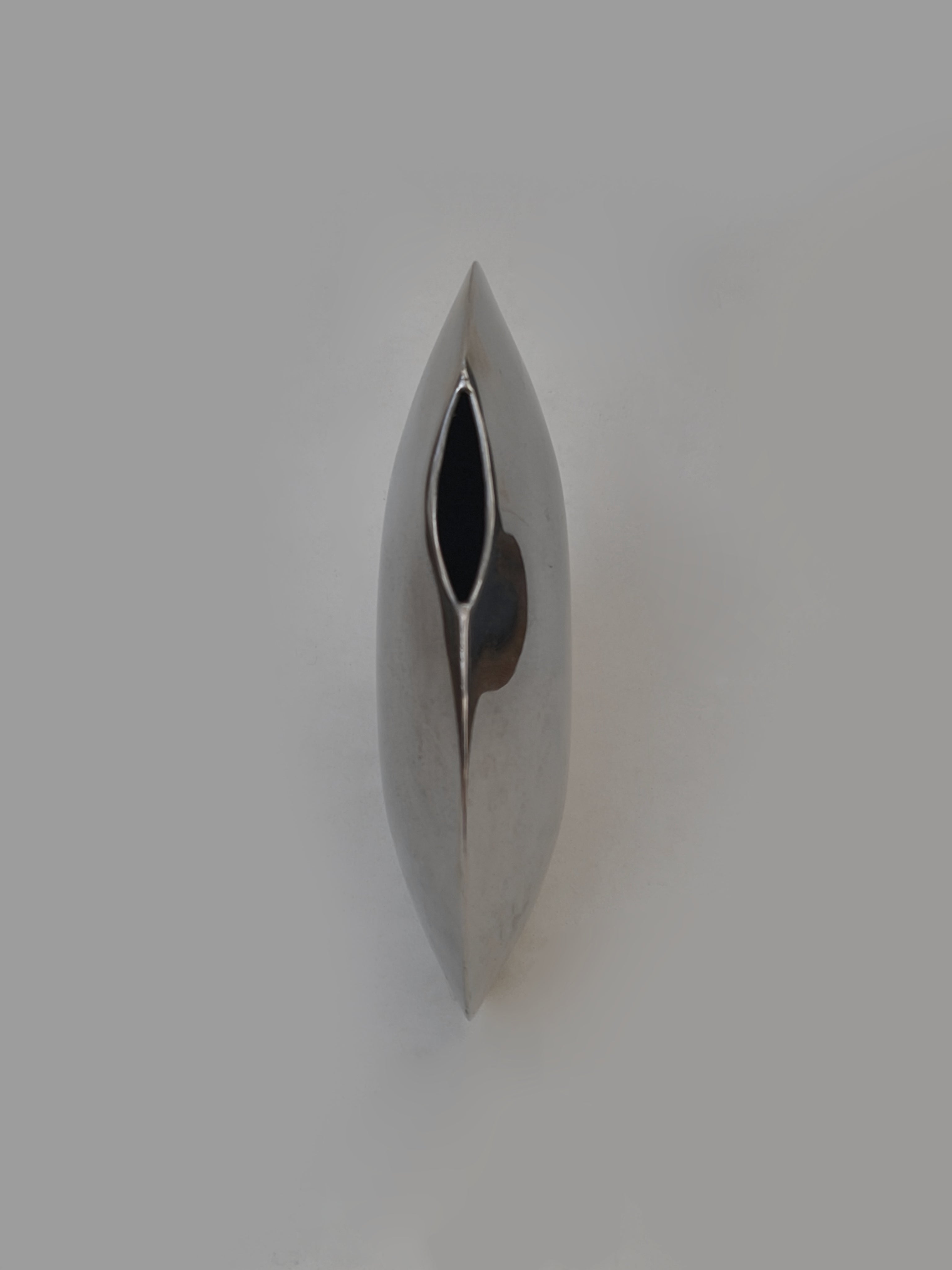 Pair of Round Vases — close-up of polished metal surface