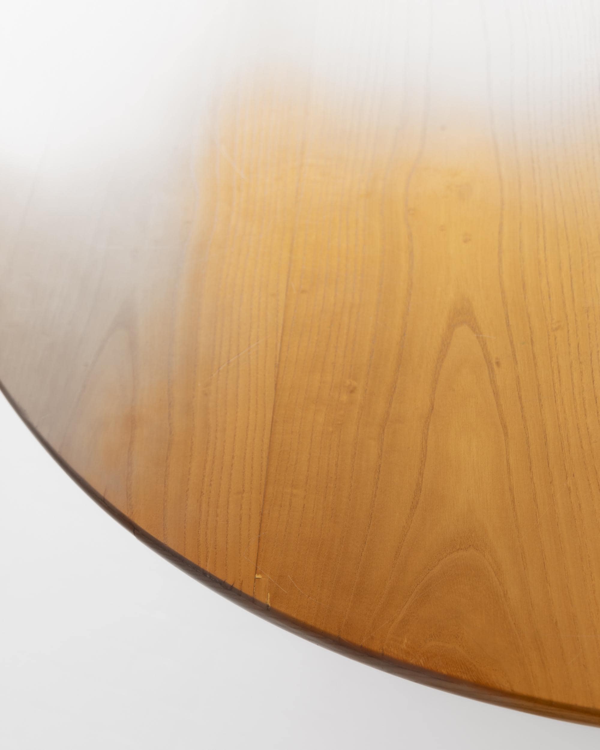 1980s Large Round Wooden Table — close-up of polished wooden surface