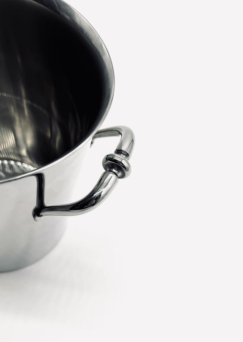 Polished stainless steel handle detail of vintage ice bucket