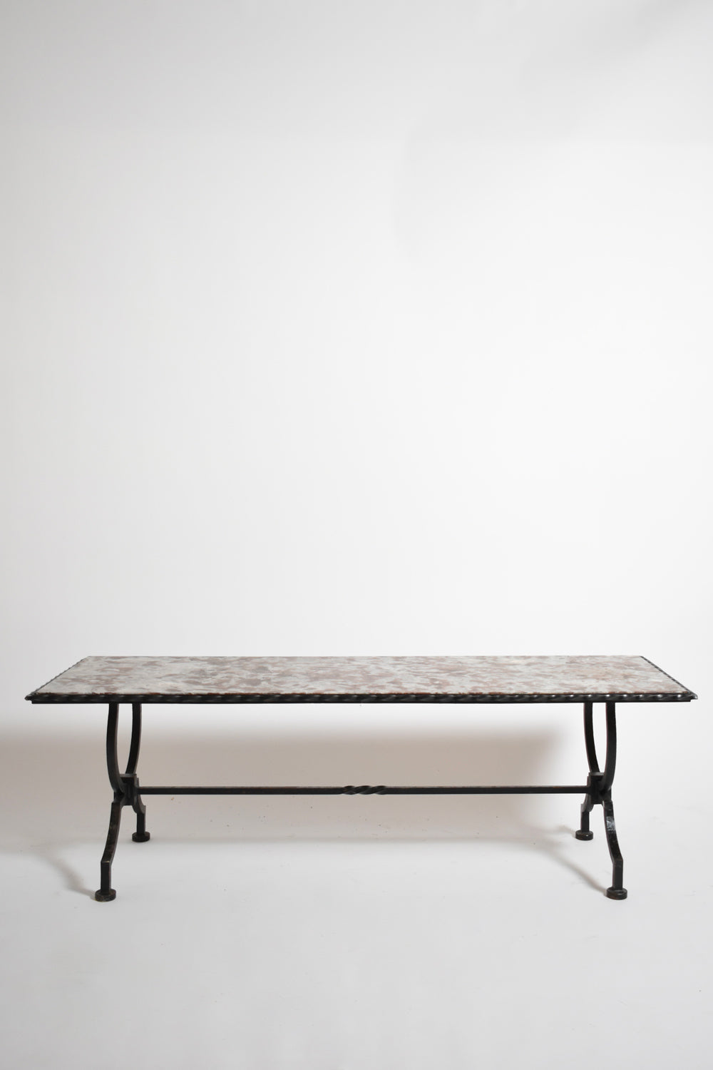 Wrought iron and marble coffee table, France 1940s — side angle showing black legs and marble top