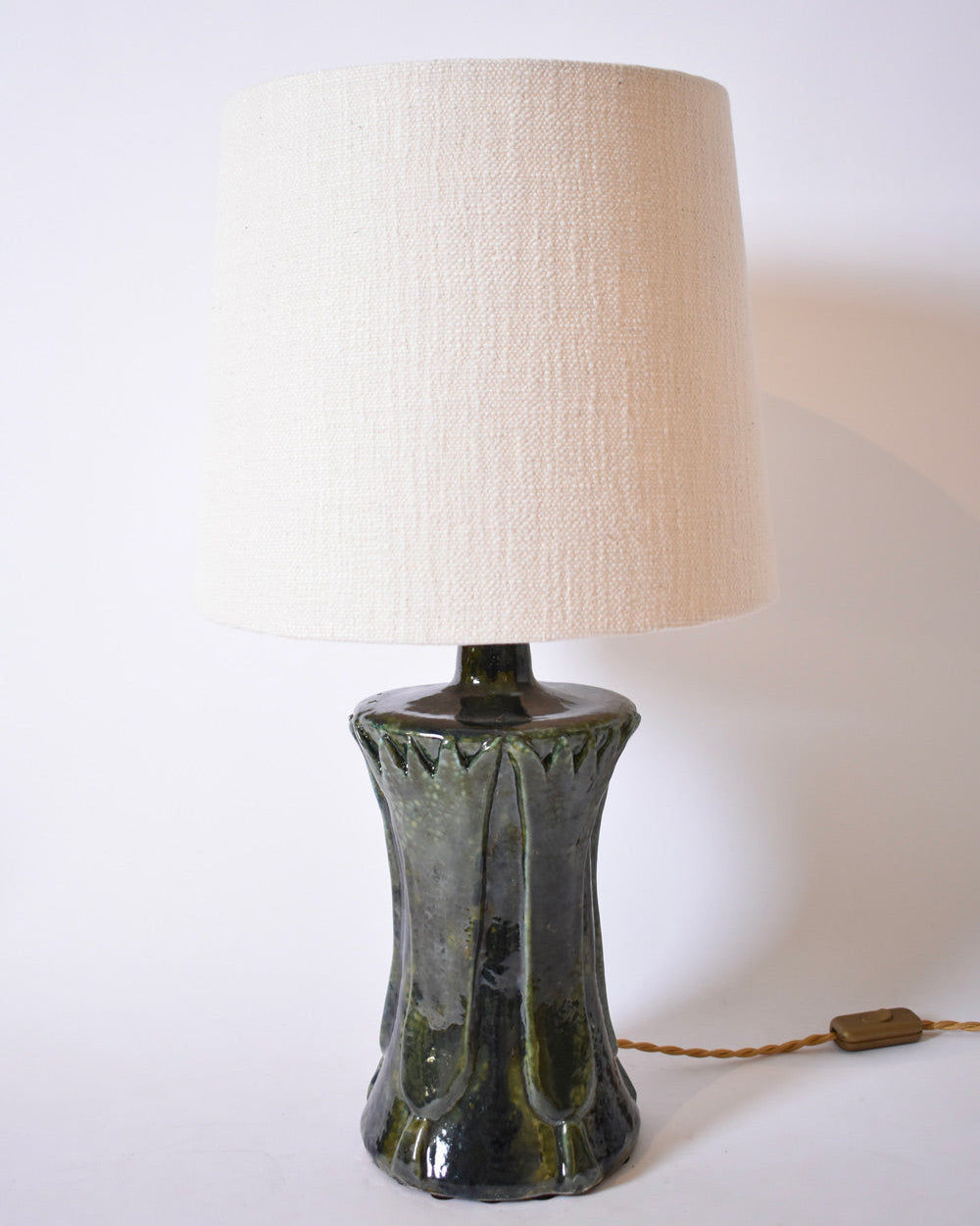 The "Kasaï" Blue Green Papyrus Ceramic Lamp by Barracuda Interiors features a glossy blue green ceramic base, a textured cream fabric shade, twisted brown cord, and switch, shown against a plain white background.