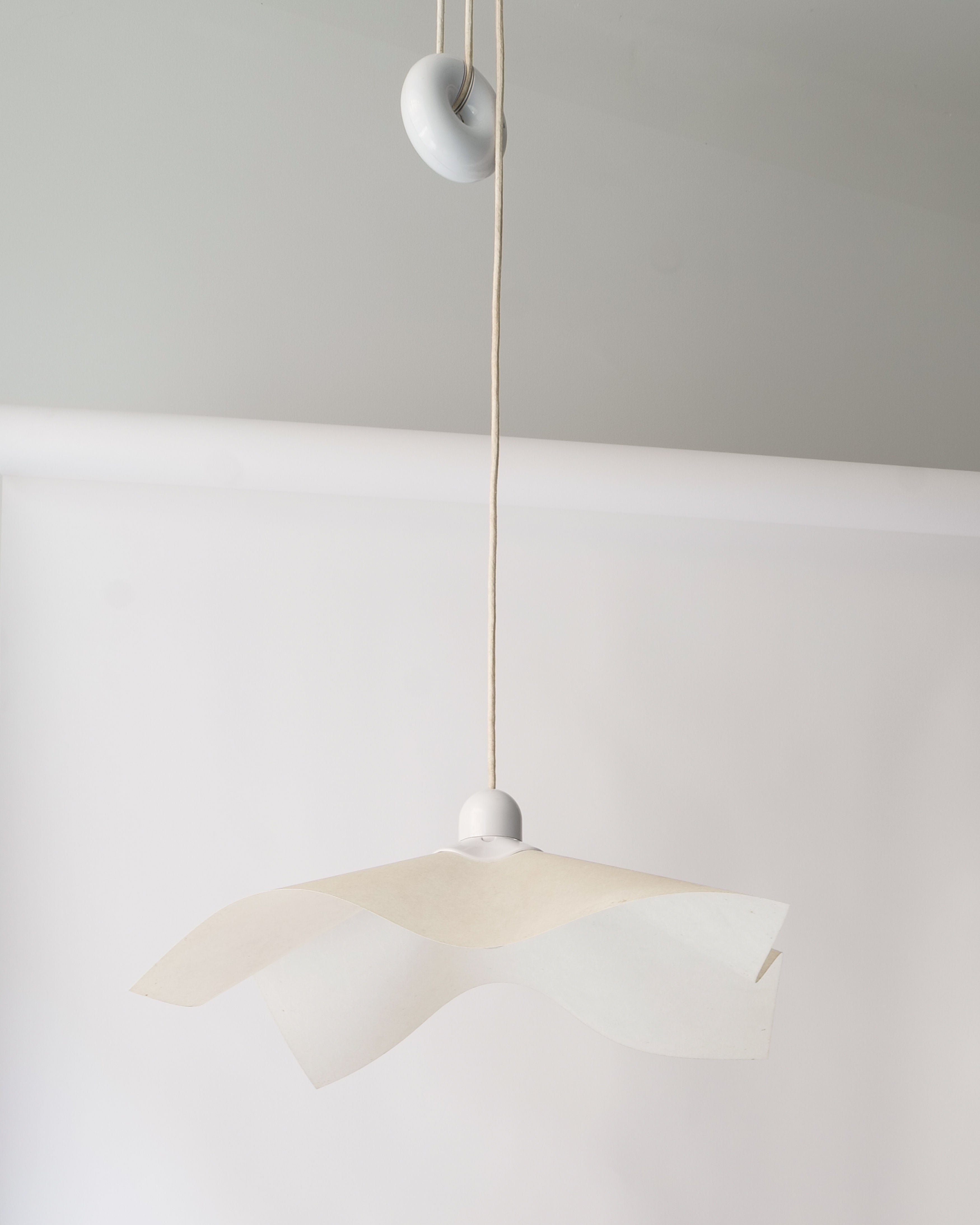 Adjustable Ceiling Lamp Mario Bellini 1970 — hanging in minimalist setting with white backdrop