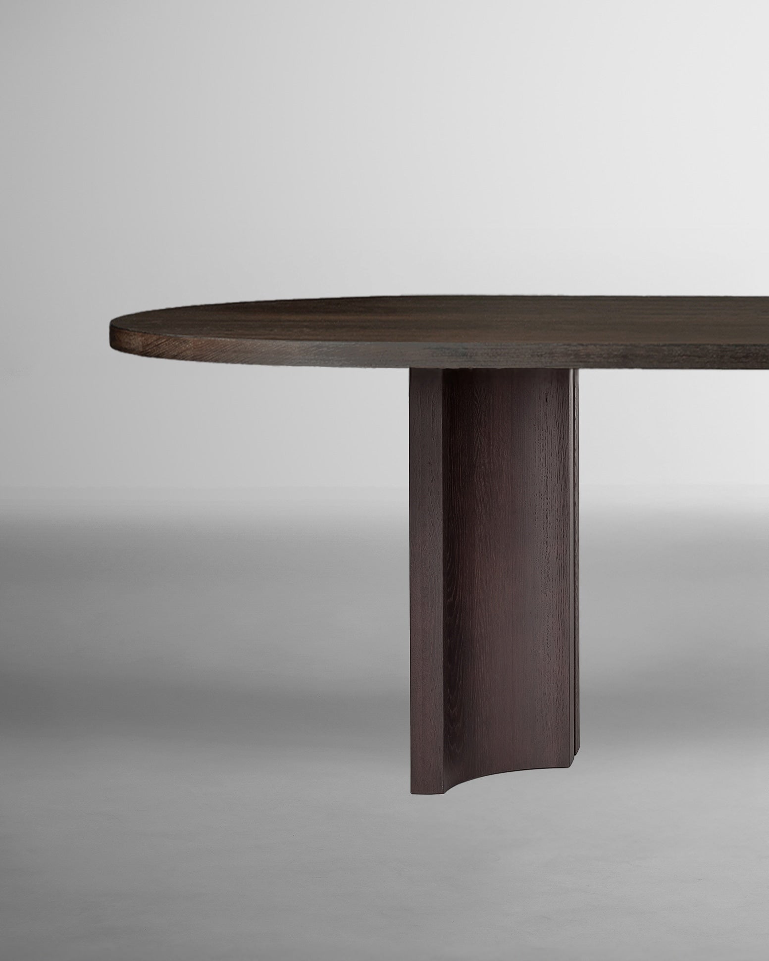 Aperta Capsule Table - Single Base — close-up of dark wood tabletop edge