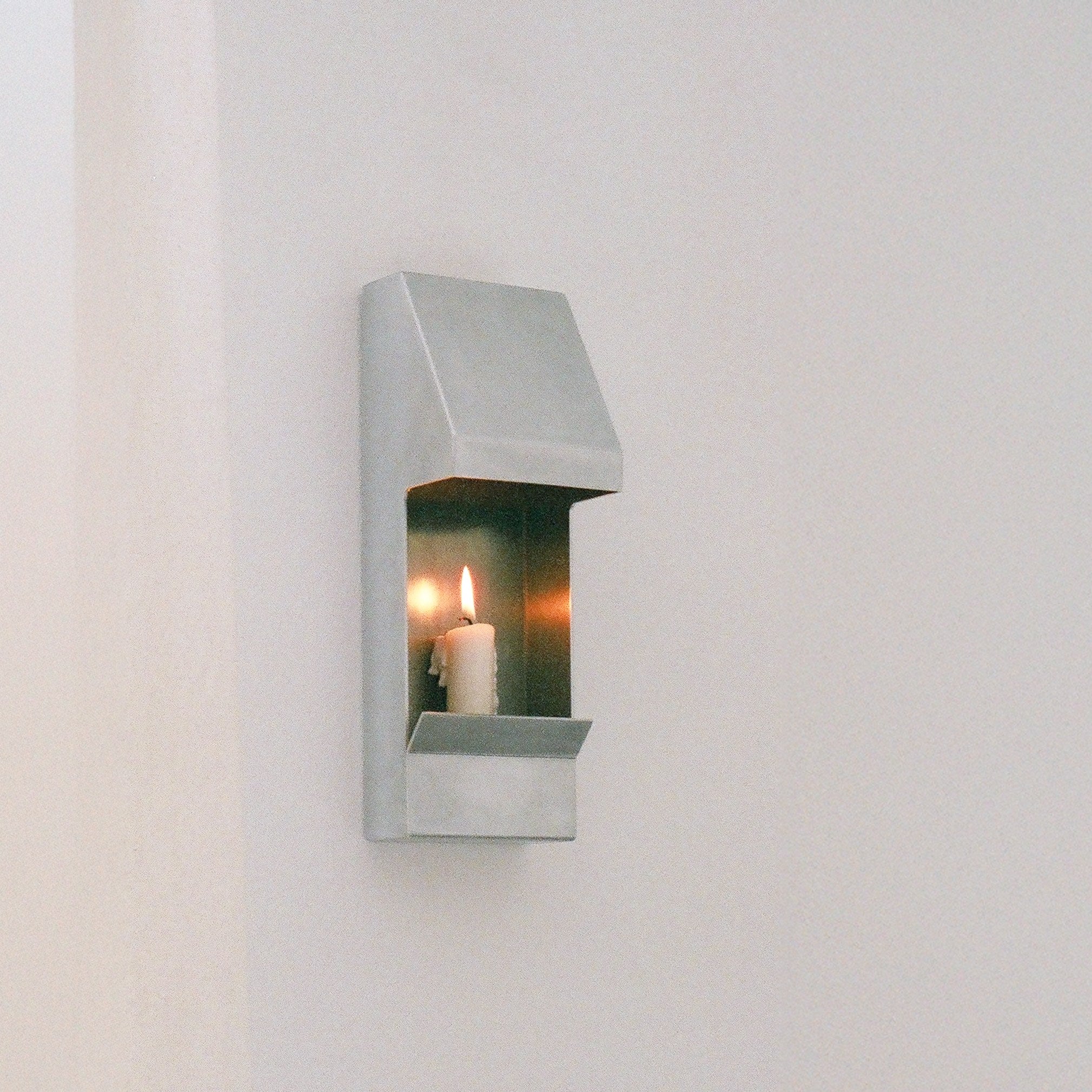 Egress Sconce Candle Holder — close-up of brushed metal finish with candle