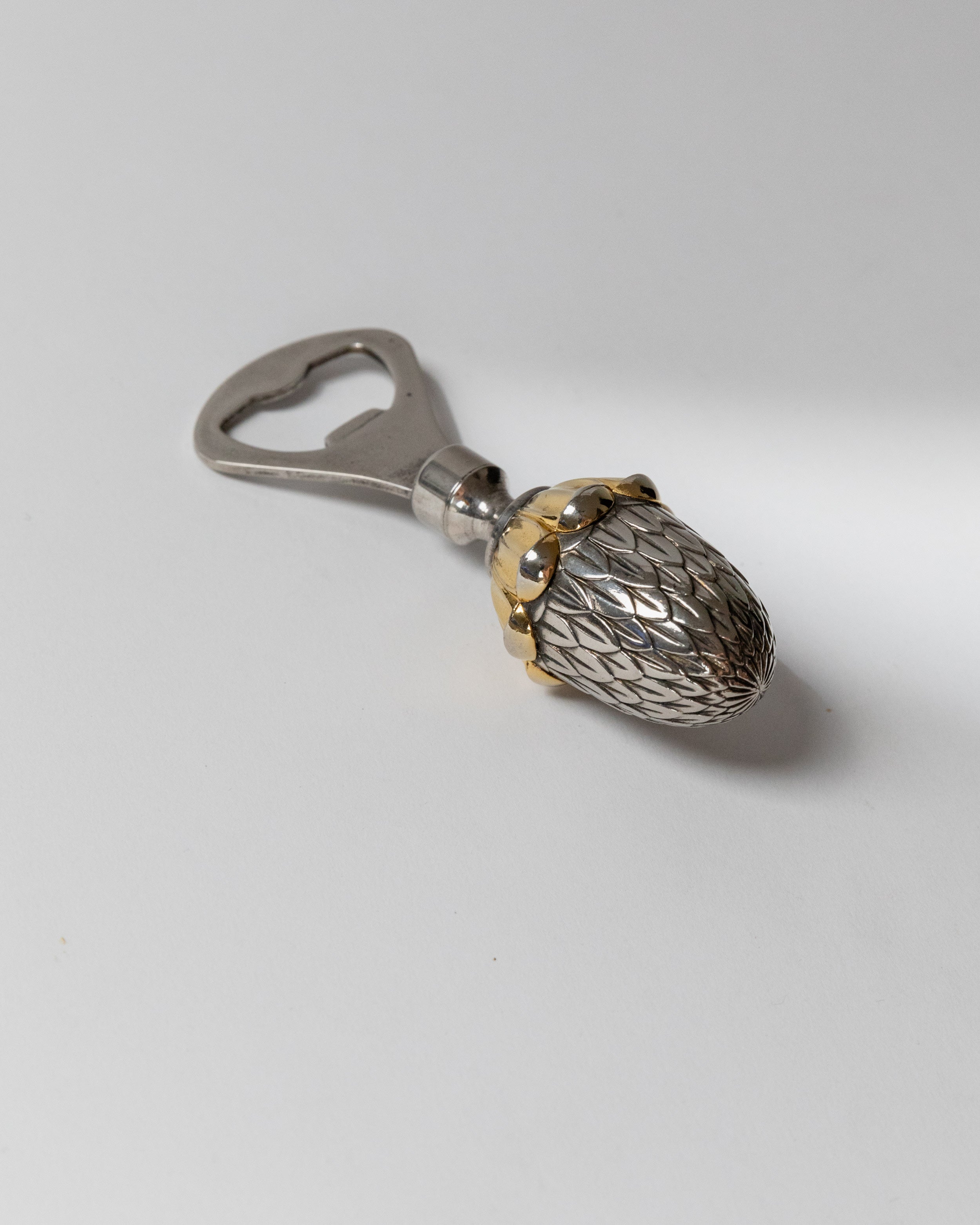 Silver plated acorn bottle opener with textured surface detail