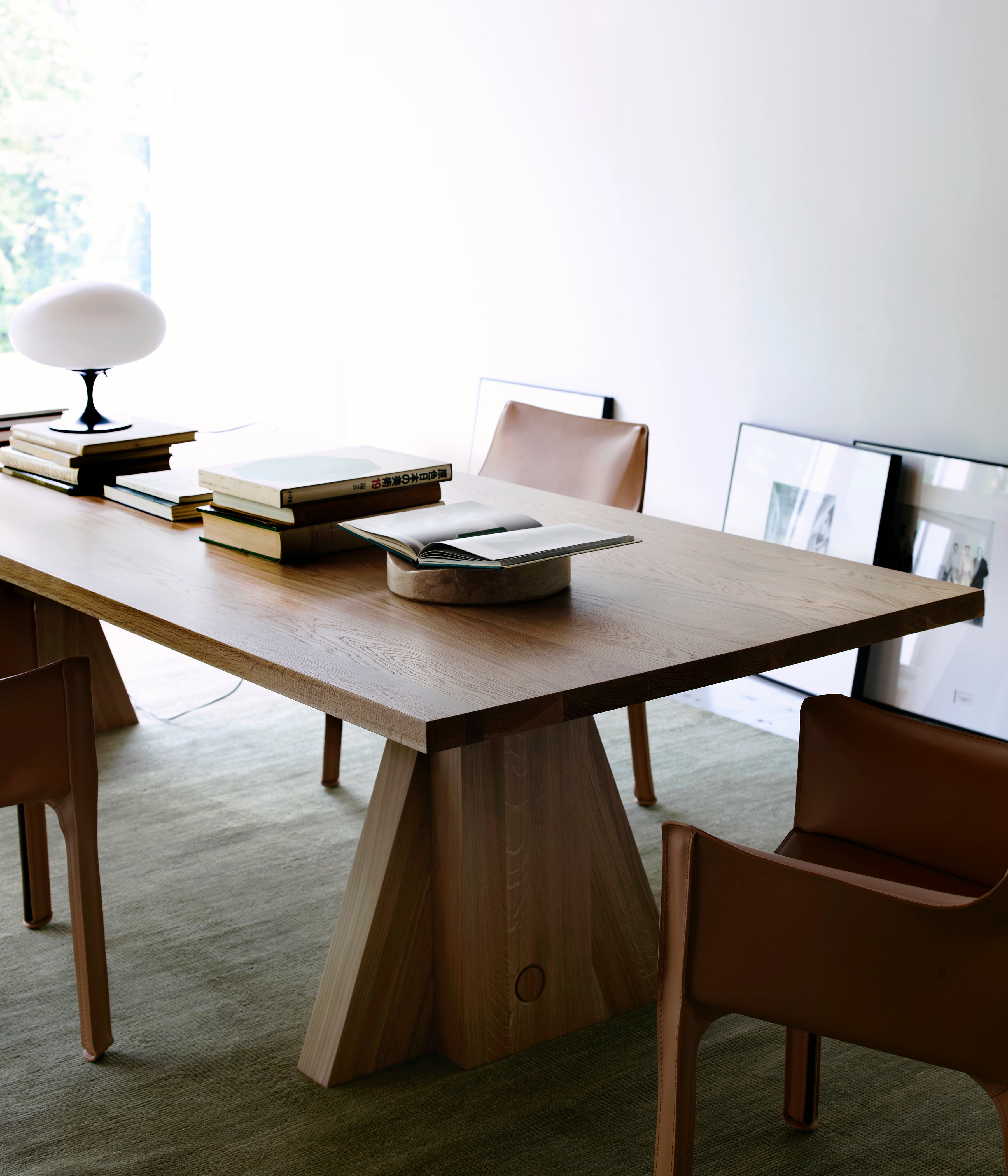 Elmyr Dining Table — top view of light wood surface with books