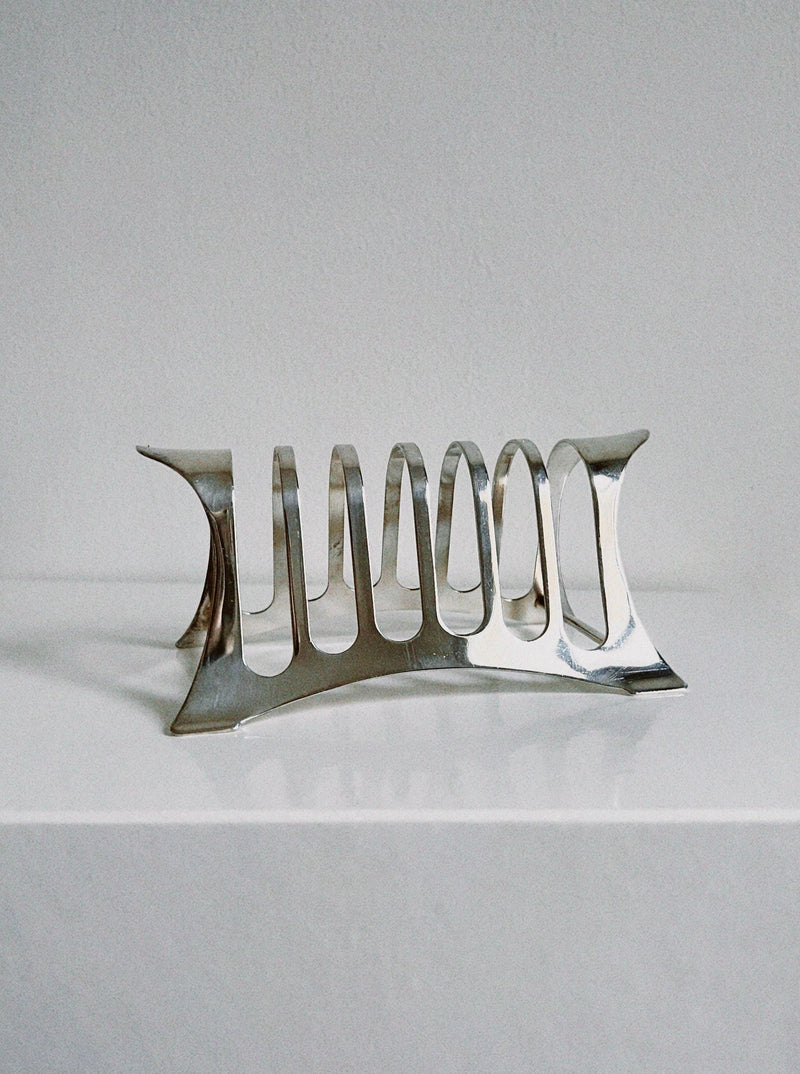 Silver modernist toast rack with curved geometric slots