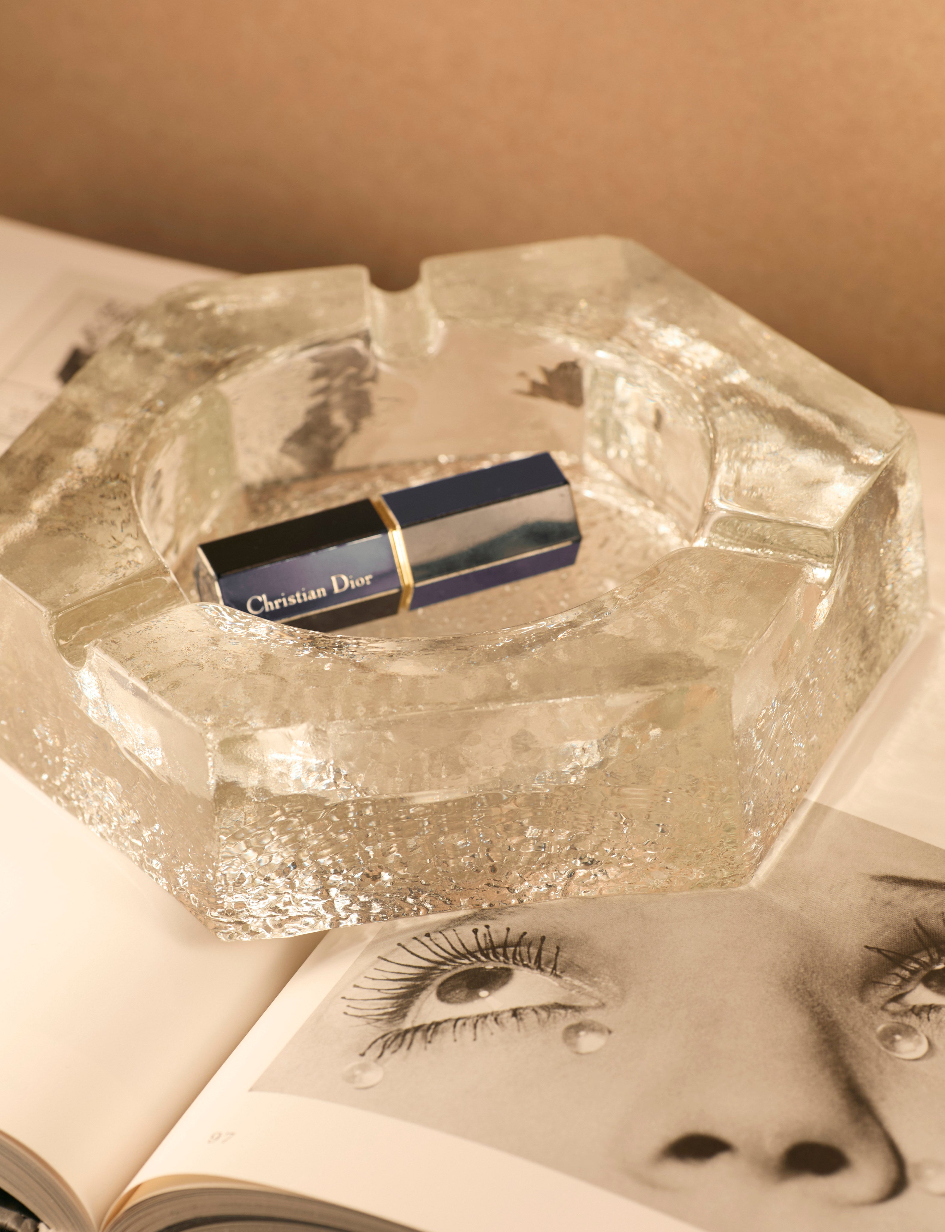 Vintage Scandinavian Ashtray in Glass and Clear Glass — top view with lipstick on open book