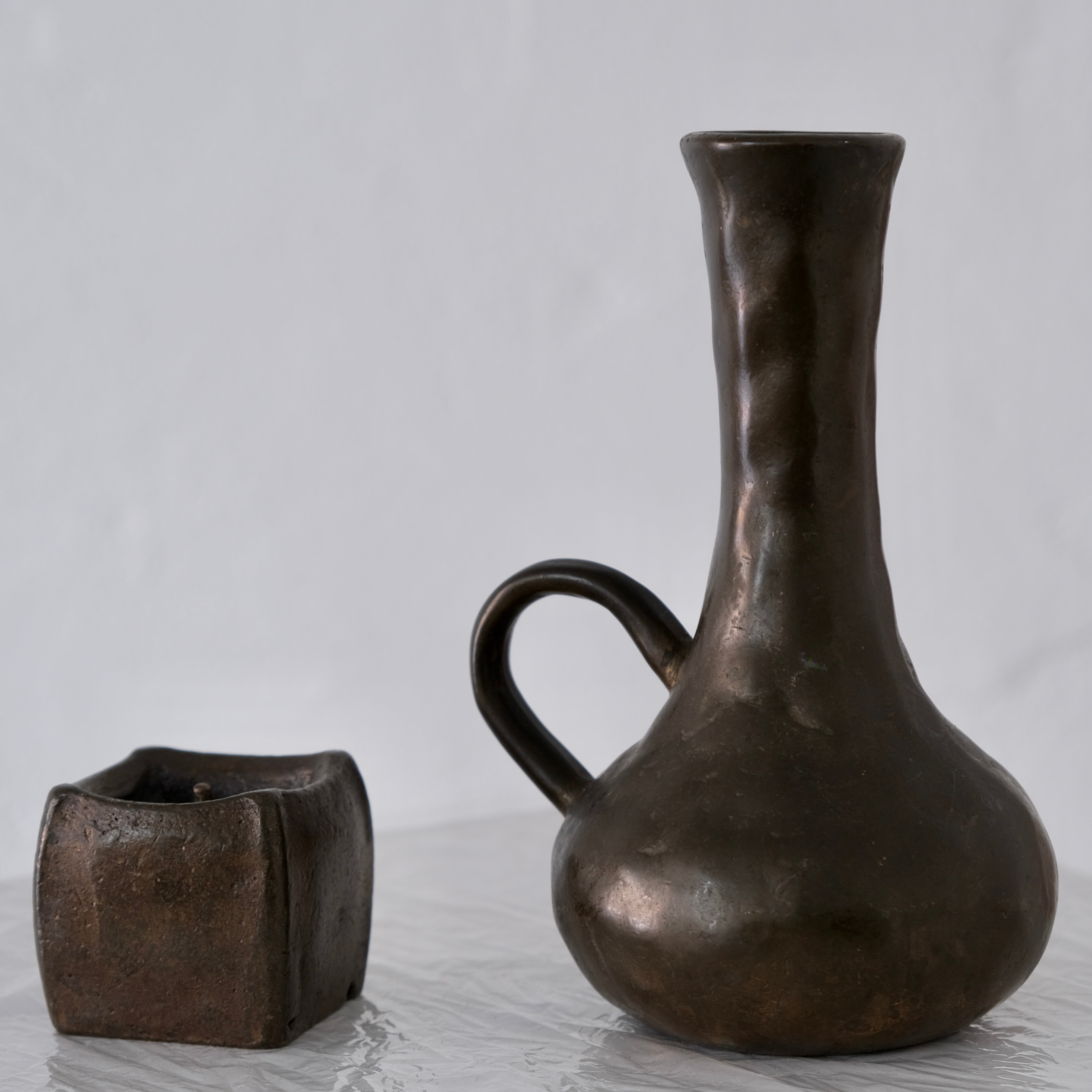 Brutalist Cast Bronze Candle Holder & Vase Set, 1970s — angled view on white surface