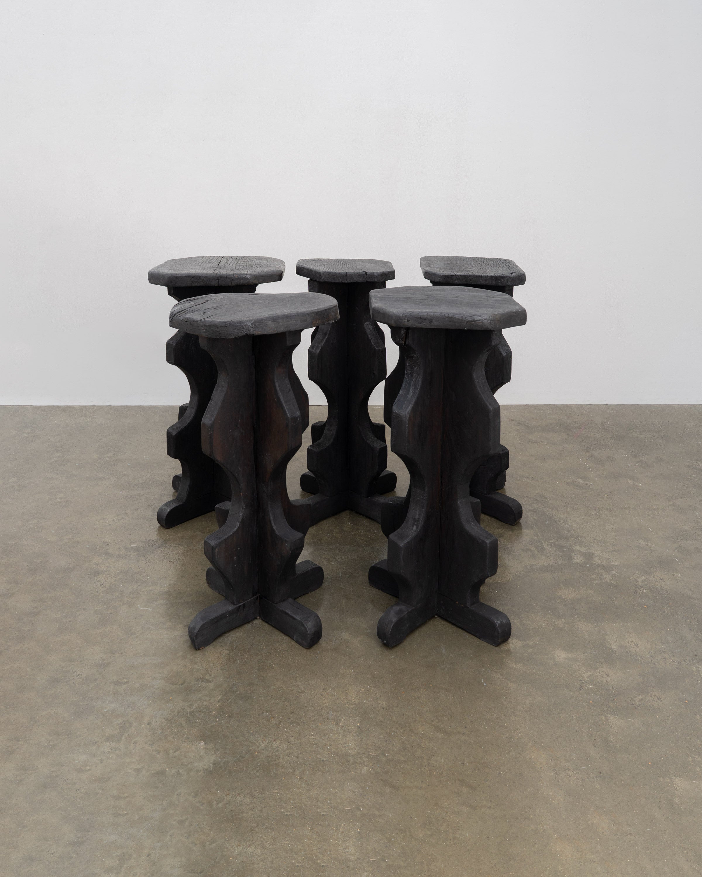 Sculptural Brutalist Bar Stools — side angle of dark wood design