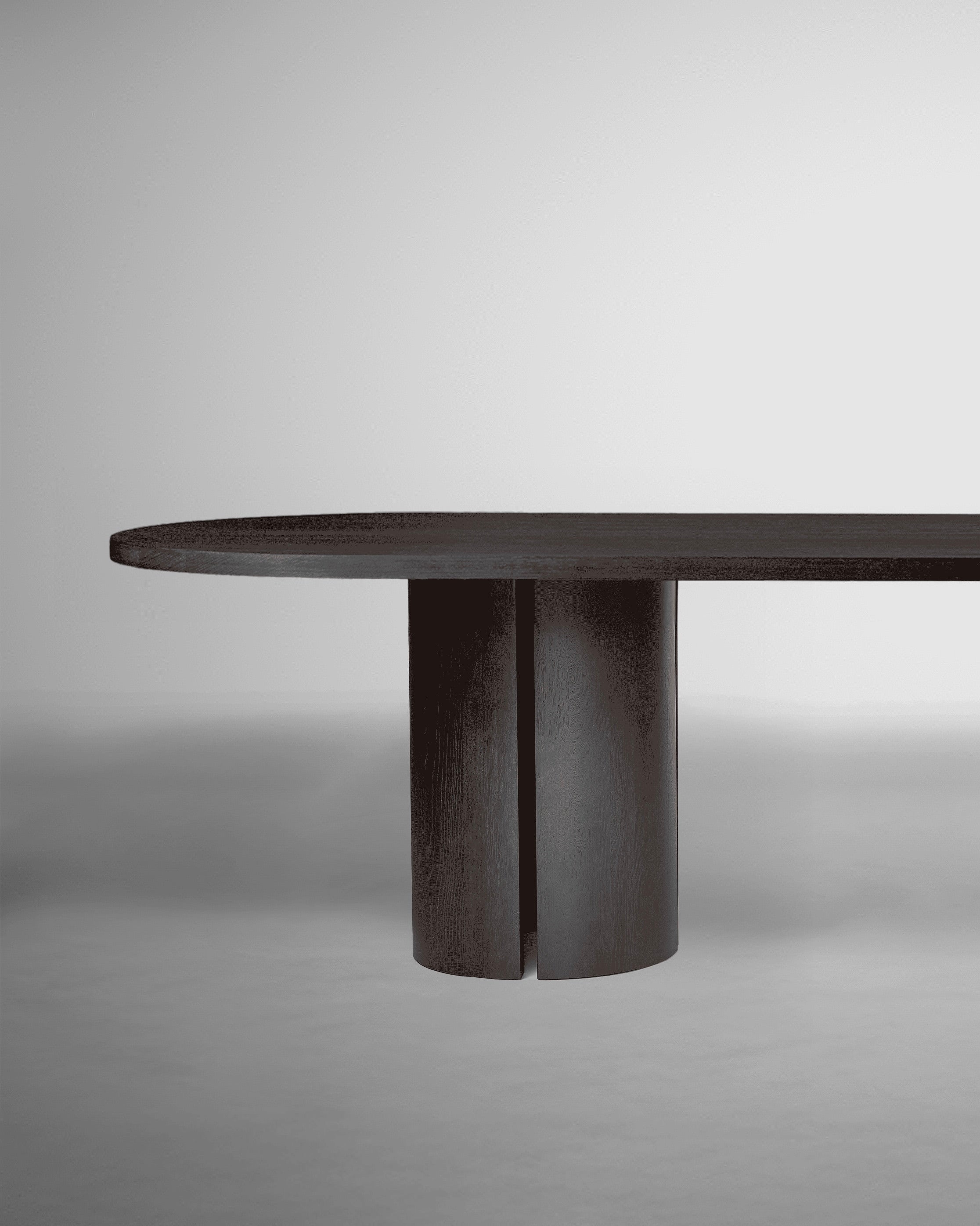 Aperta Table - Capsule - Double Base — side angle showing dark wood finish