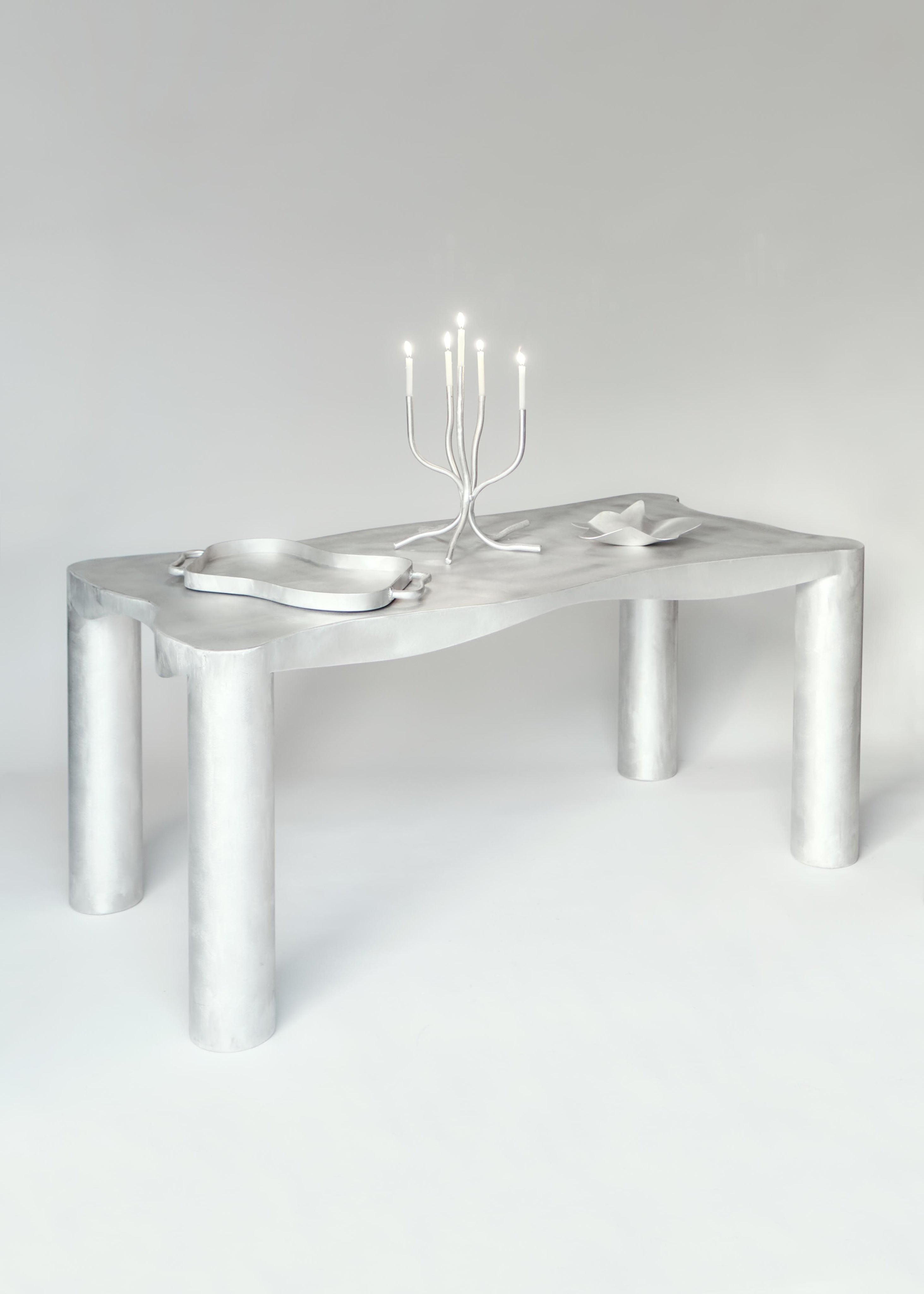 Aluminum Dining Table — angled view with modern candle holder