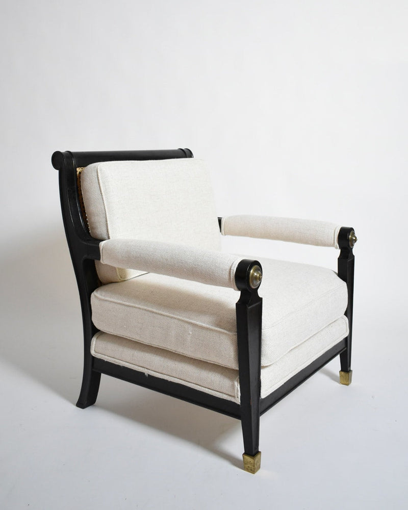 Pair of neoclassical ebonised wood armchair, 1960s — angled view showing upholstery and brass accents