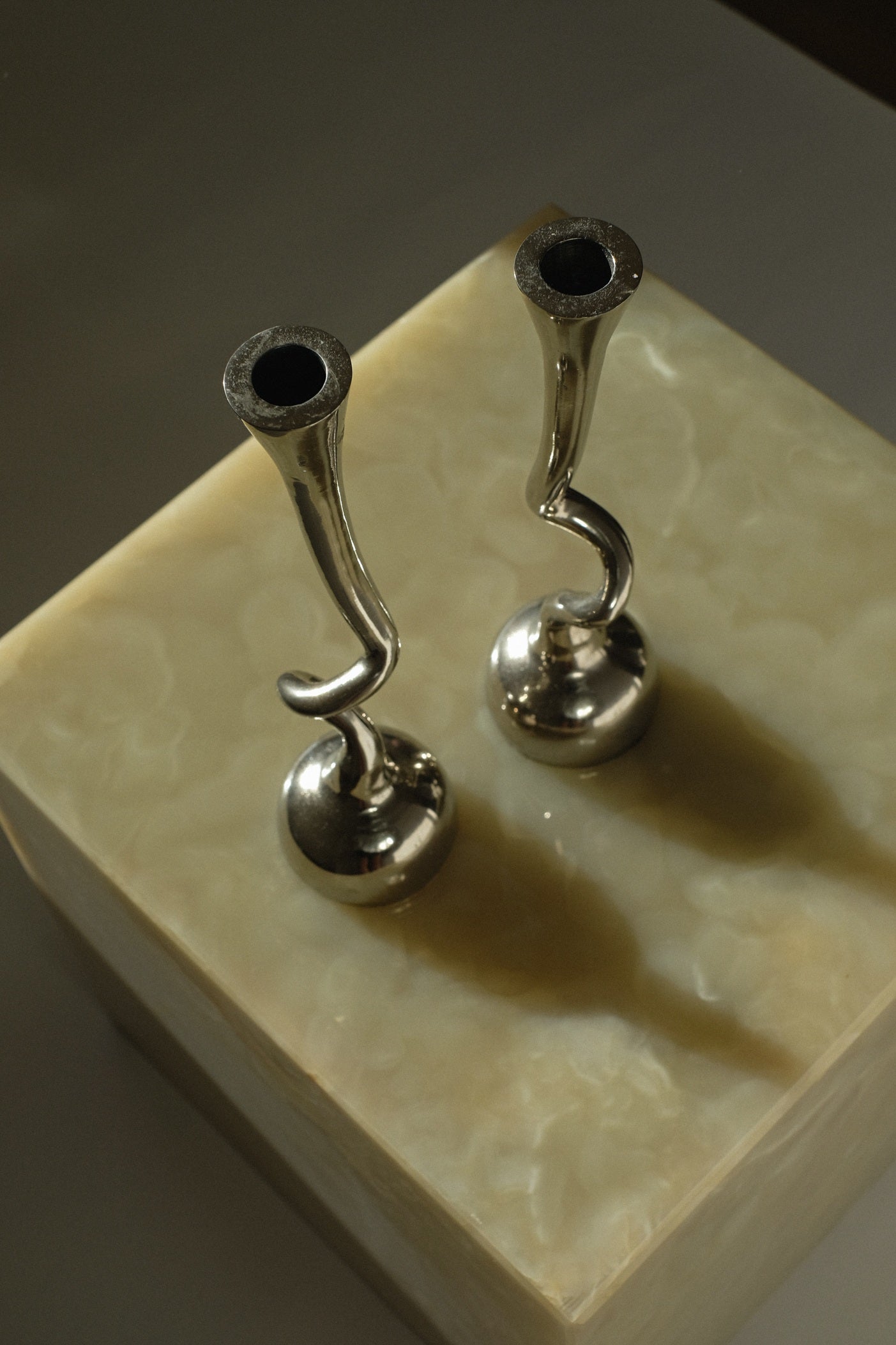 Pair of Curled Candleholders — top view on glossy surface