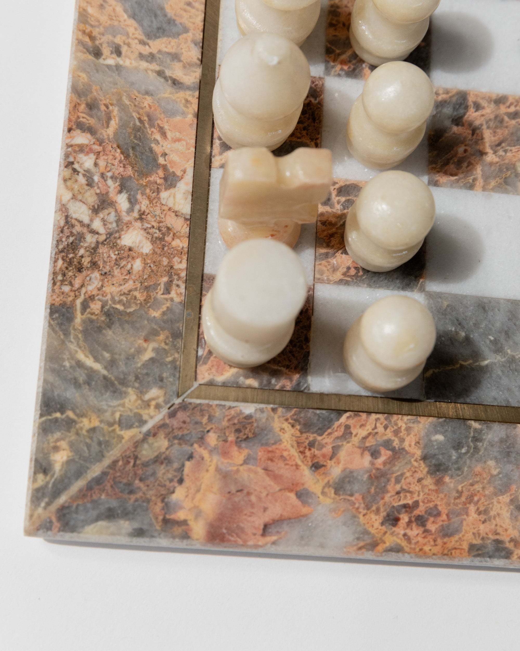 Vintage marble chessboard detail with white onyx chess pieces