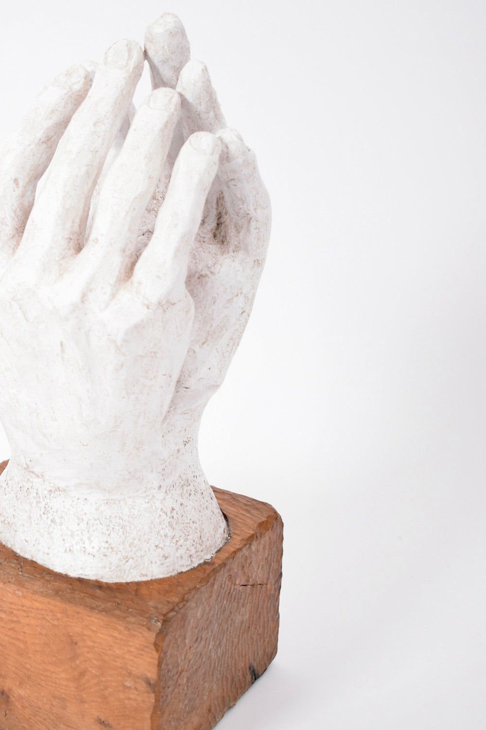 The Barracuda Interiors Rodin Style Plaster and Wood Sculpture (1960s) features two white hands close together, palms inward, mounted on a square wooden base against a plain white background.