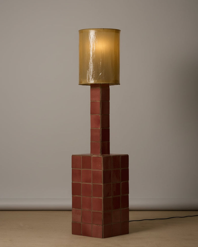 Jura floor lamp with red brick base and golden cylindrical shade