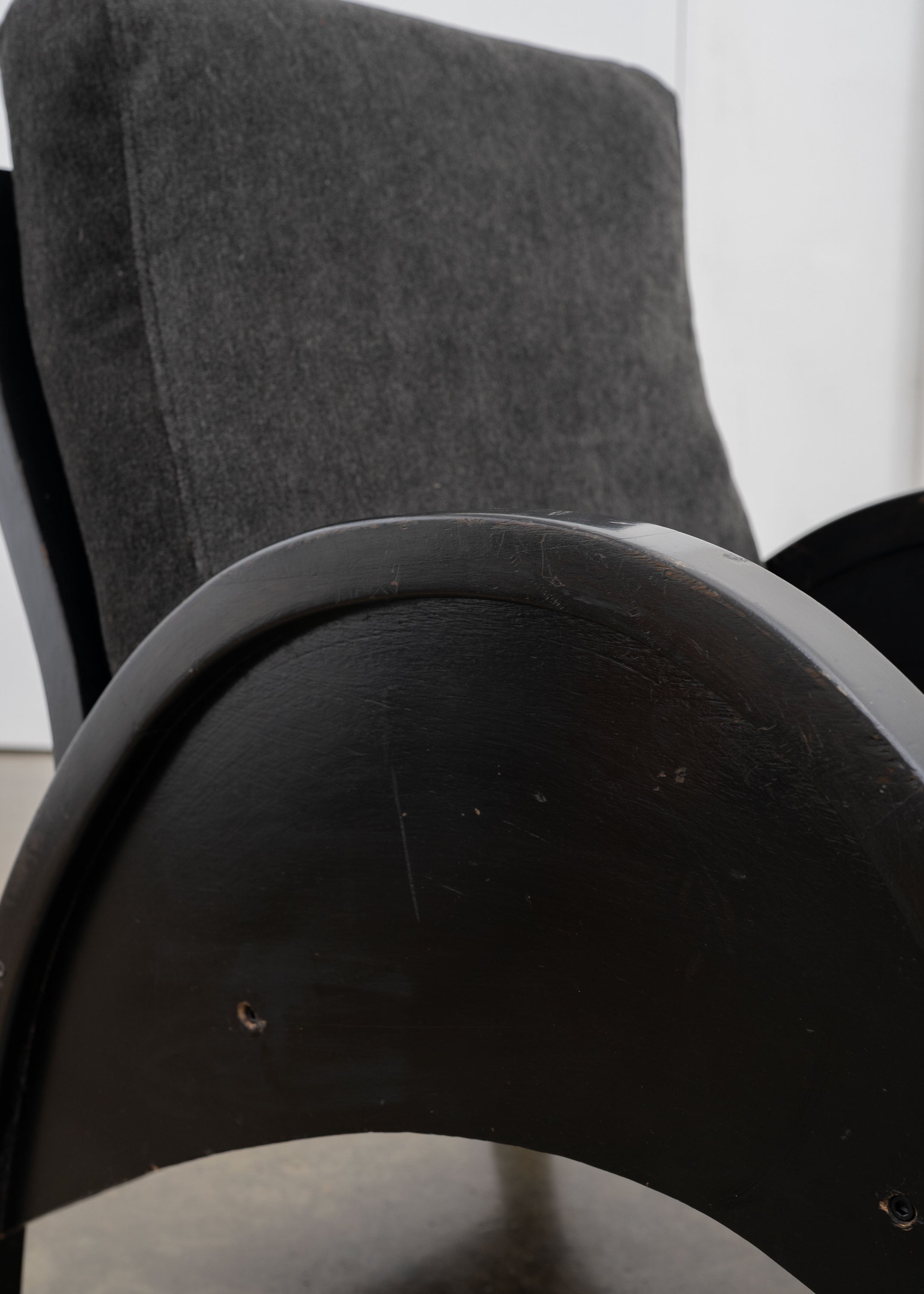 Modernist Armchairs, c.1950 — angled view of dark wood armrest and fabric upholstery