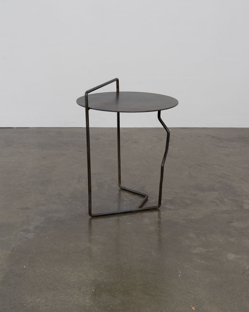 Sculptural Patinated Steel Side Table — close-up of round top and base