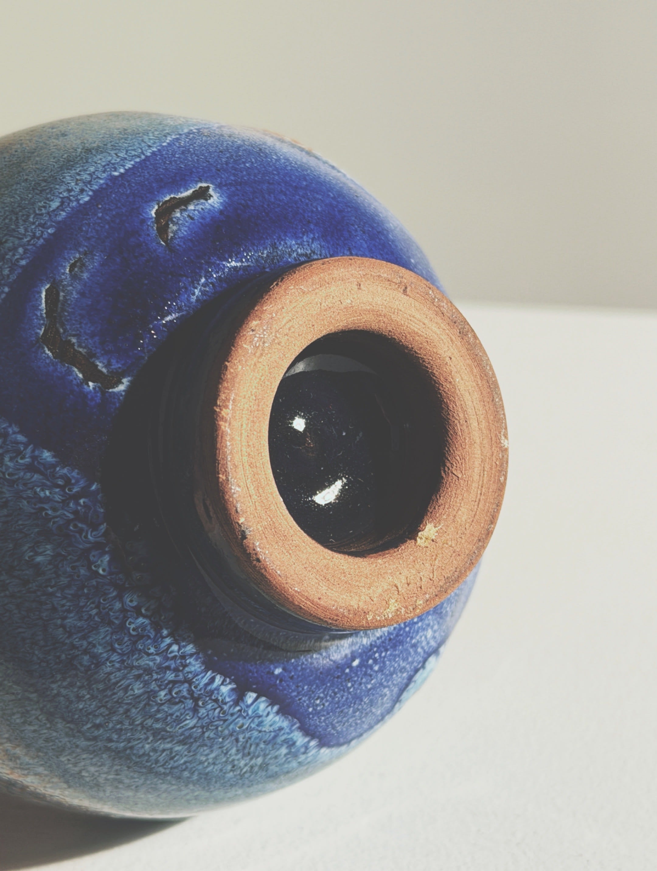 Small Ceramic Vase, Vallauris, circa 1960. — side angle showing blue glaze and terracotta rim