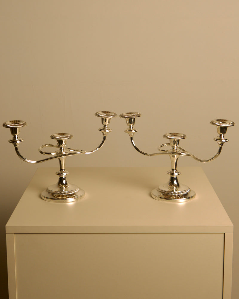 Pair of Italian metal "Medusa" candlesticks, 1980s — close-up of polished silver finish