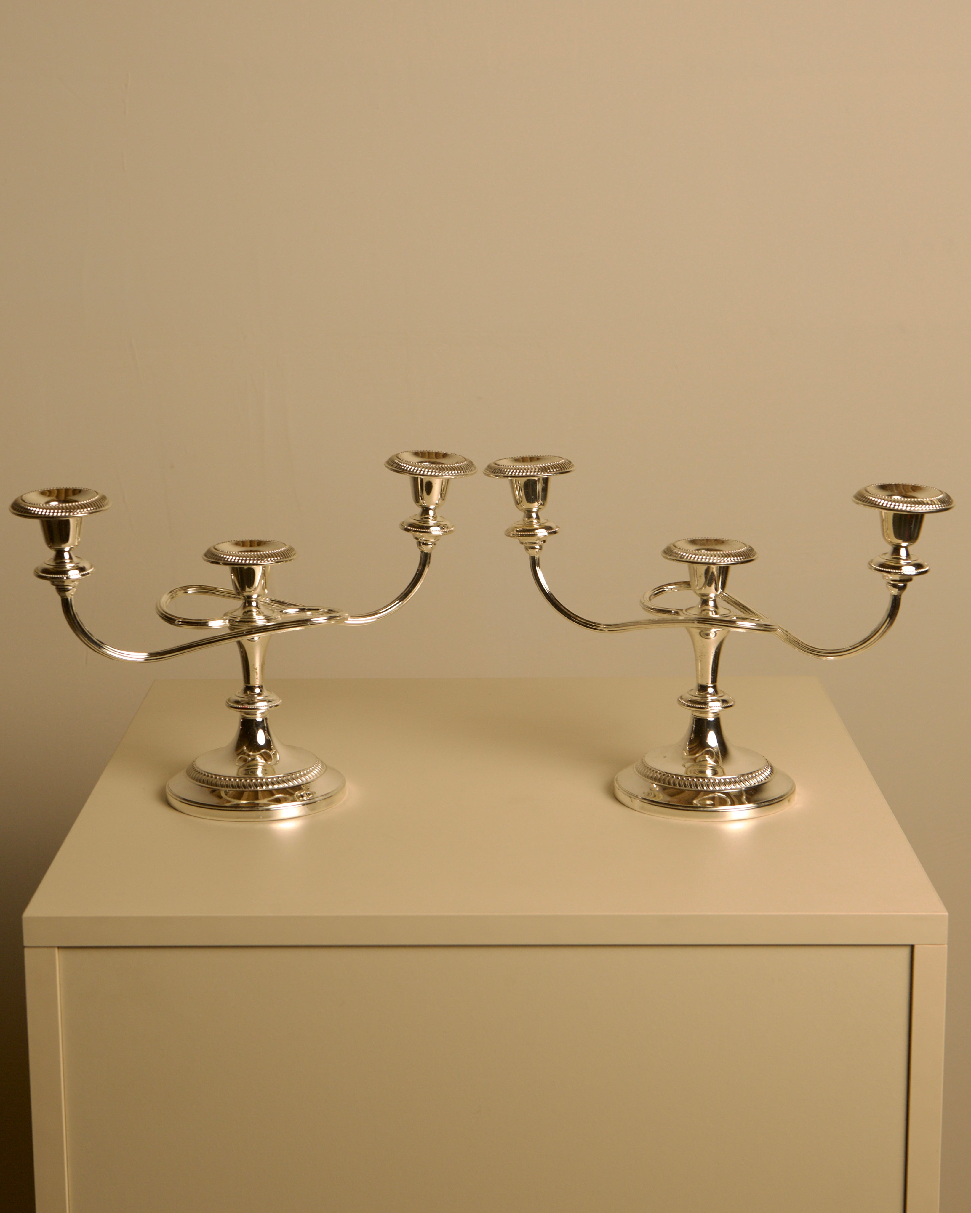 Pair of Italian metal "Medusa" candlesticks, 1980s — close-up of polished silver finish