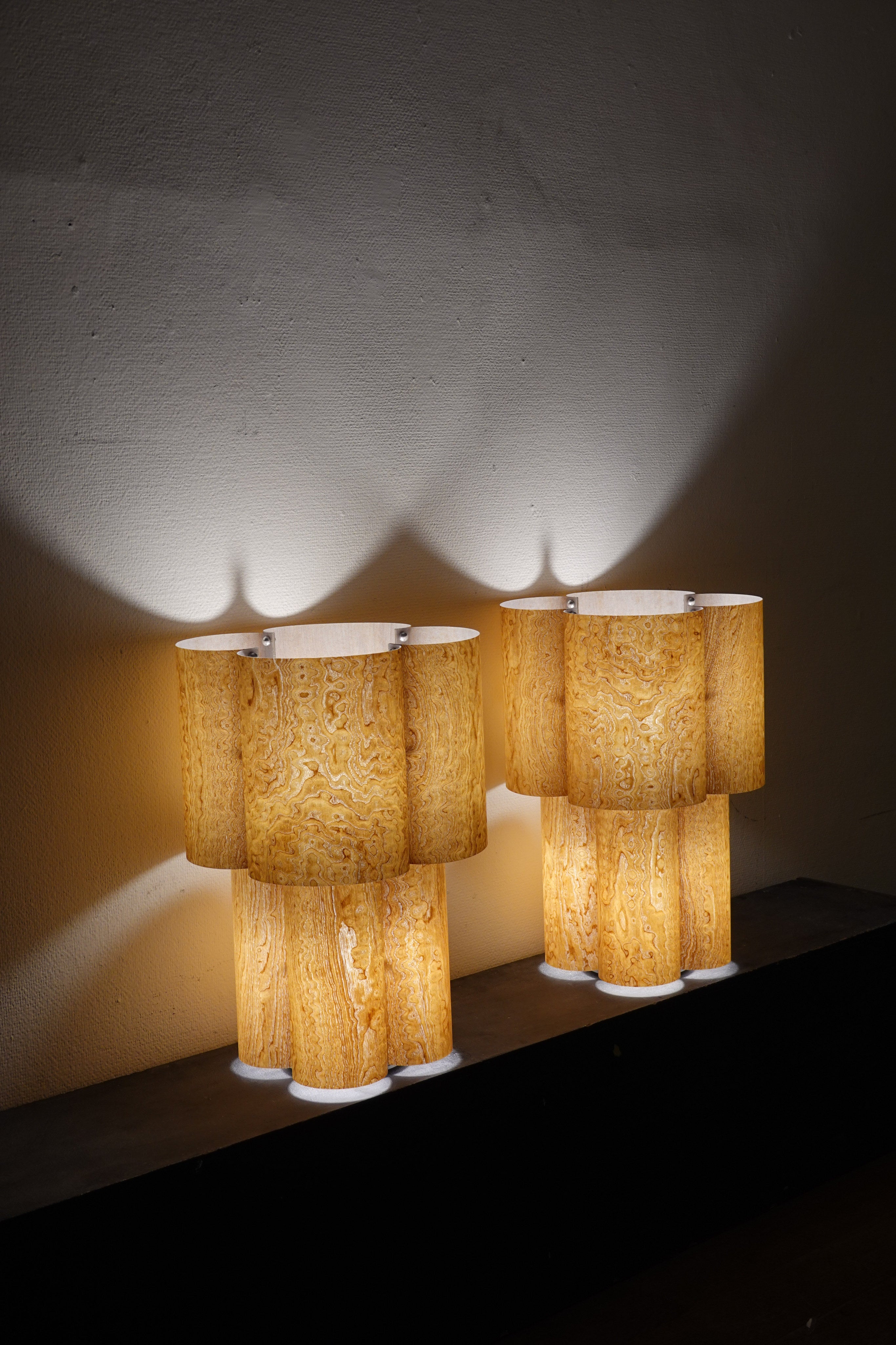 Soom Ash Table Lamp — two lamps on dark shelf with warm light
