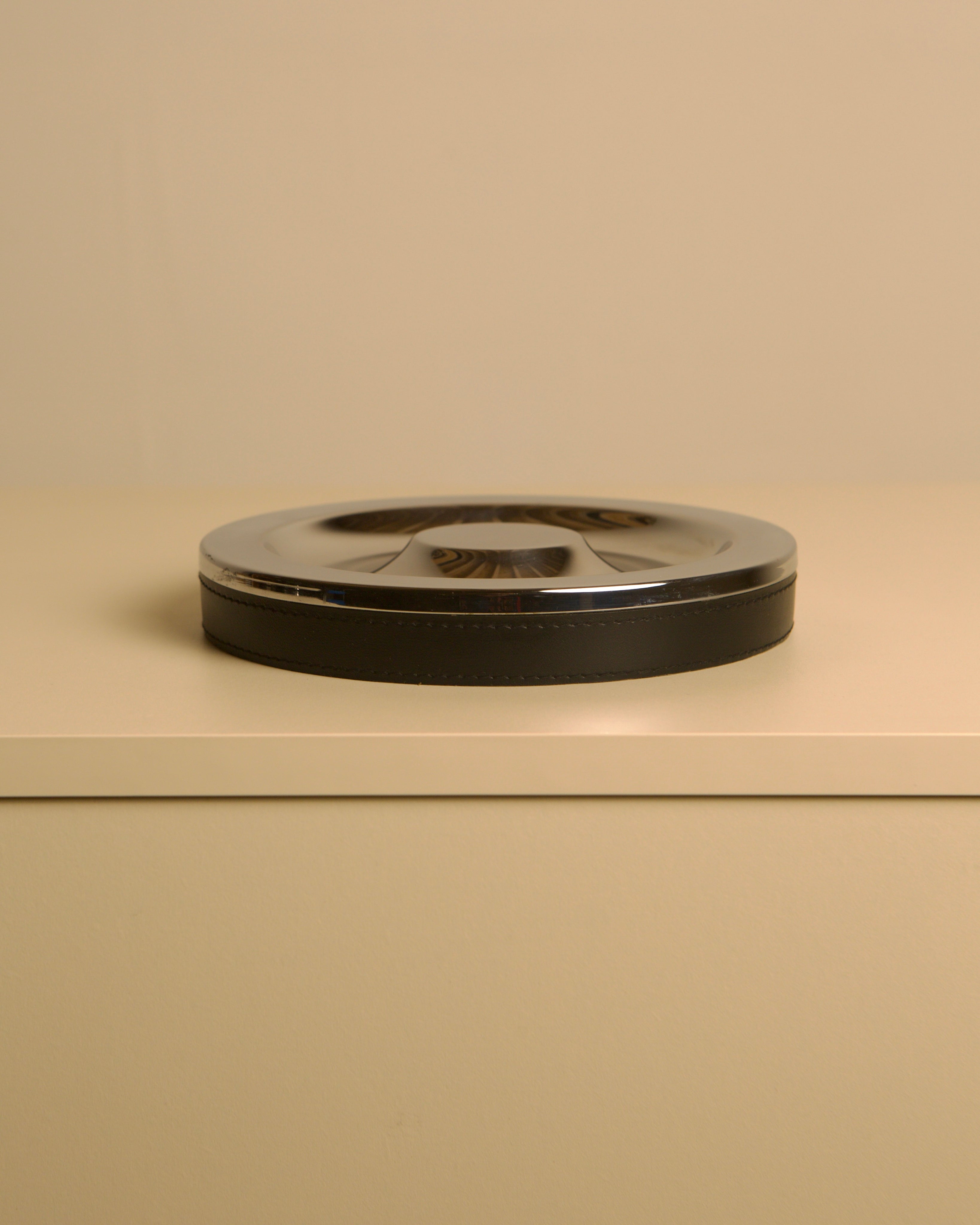 Italian Metal and Black Leather Valet Tray, 70s — side angle on neutral background