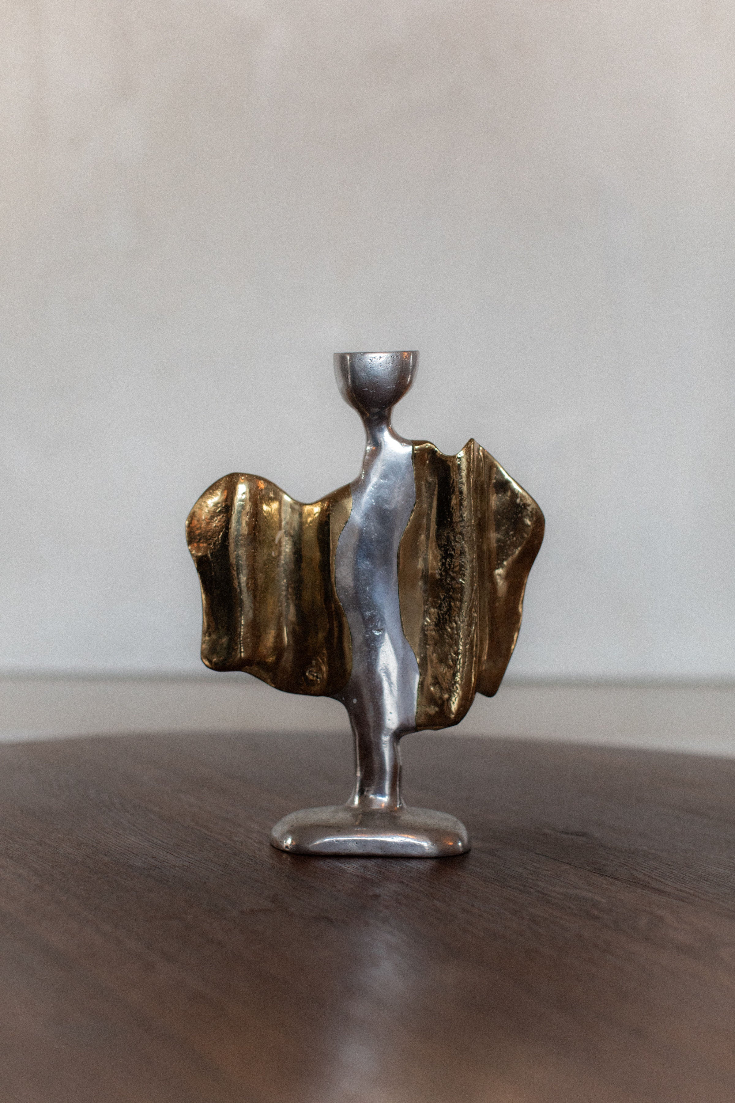 Sculptural bronze and silver candleholder with flowing organic form