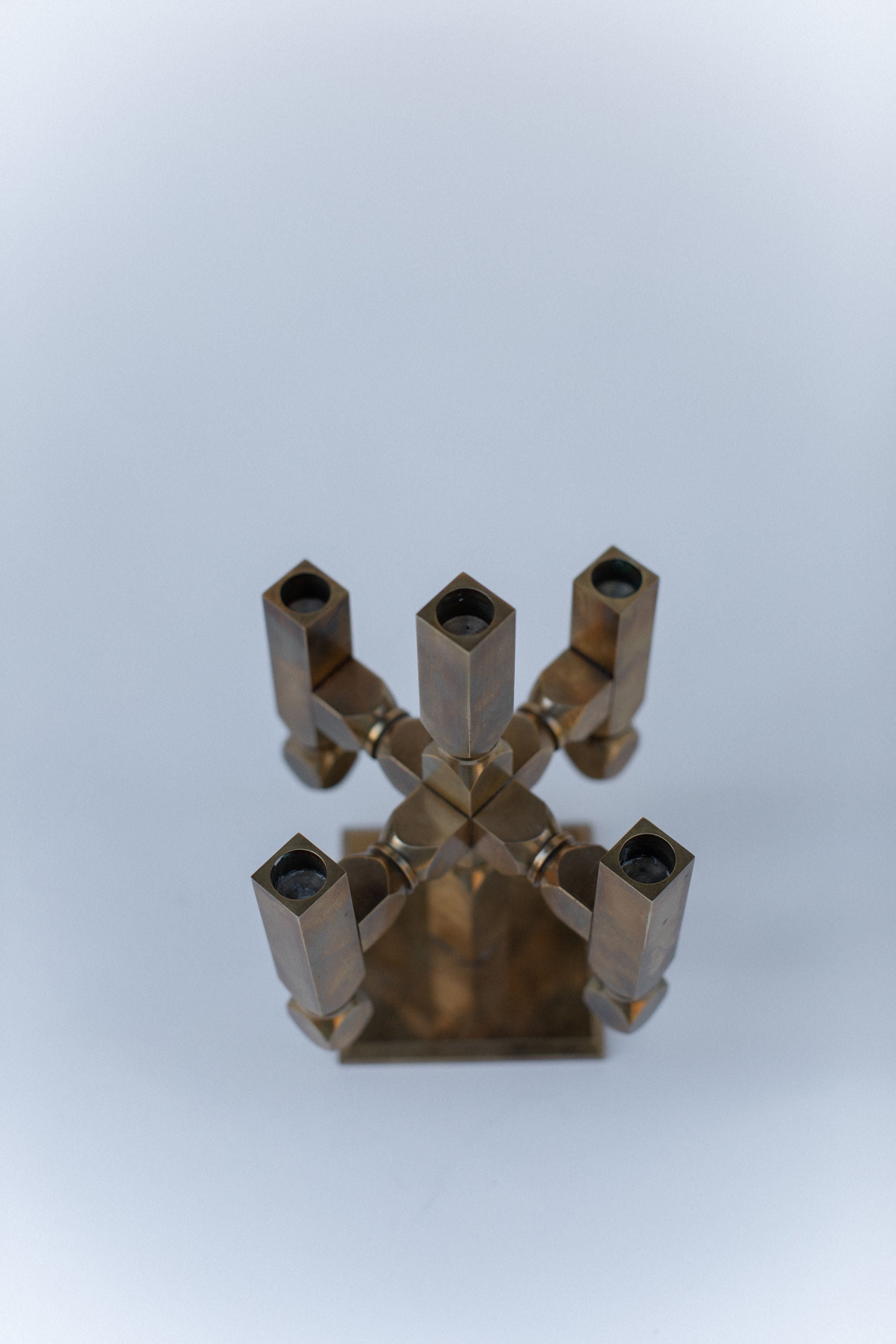 Brutalist brass candleholder with geometric square tubes radiating from center