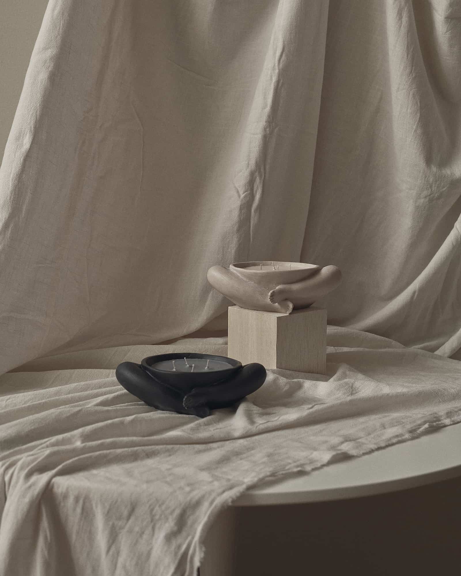 Contemporary Sculptural Candle in Resin and Stone – Biblichor by Marcela Cure — angled view on textured fabric backdrop