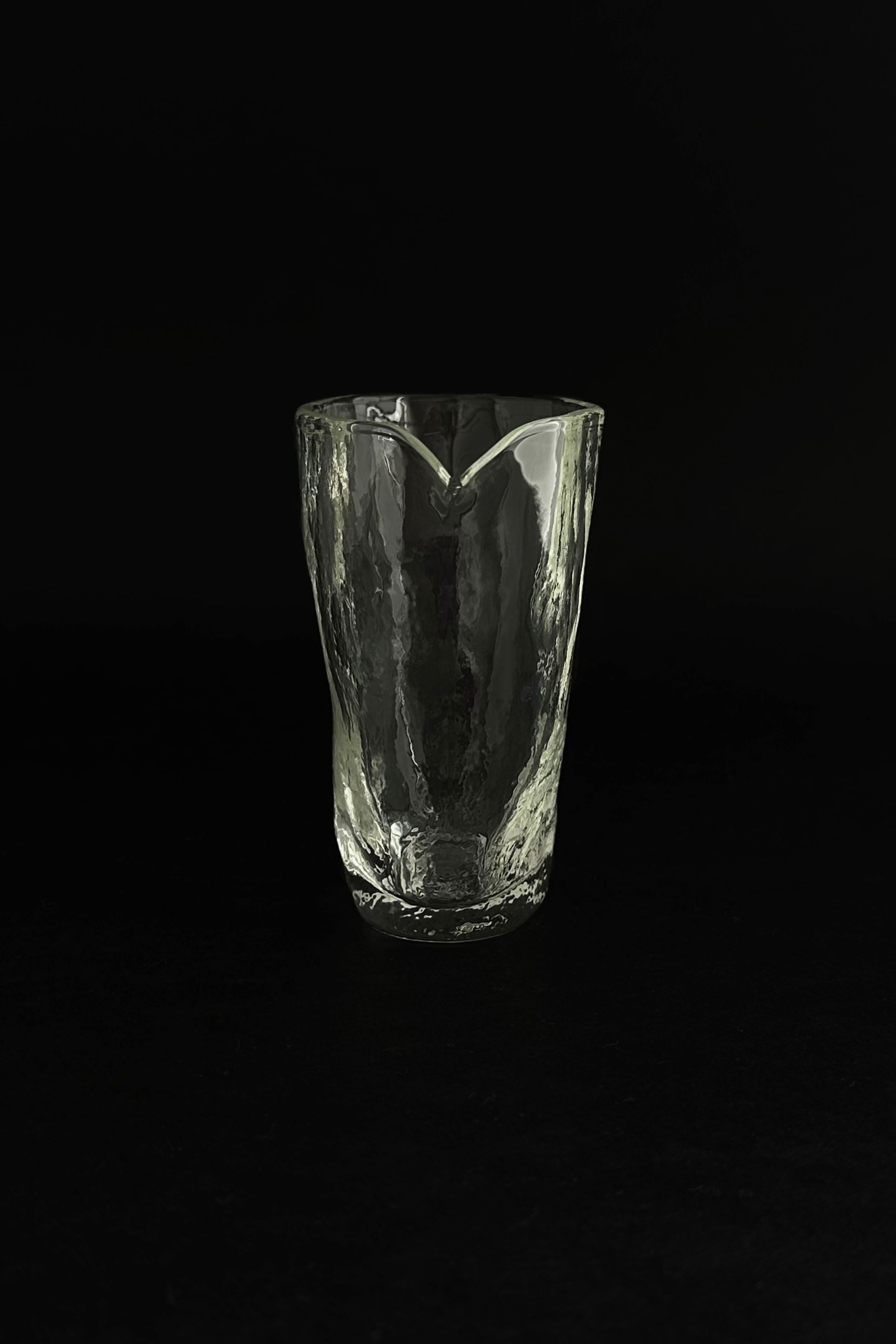 ELYSIUM' small glass pitcher — side angle on black background