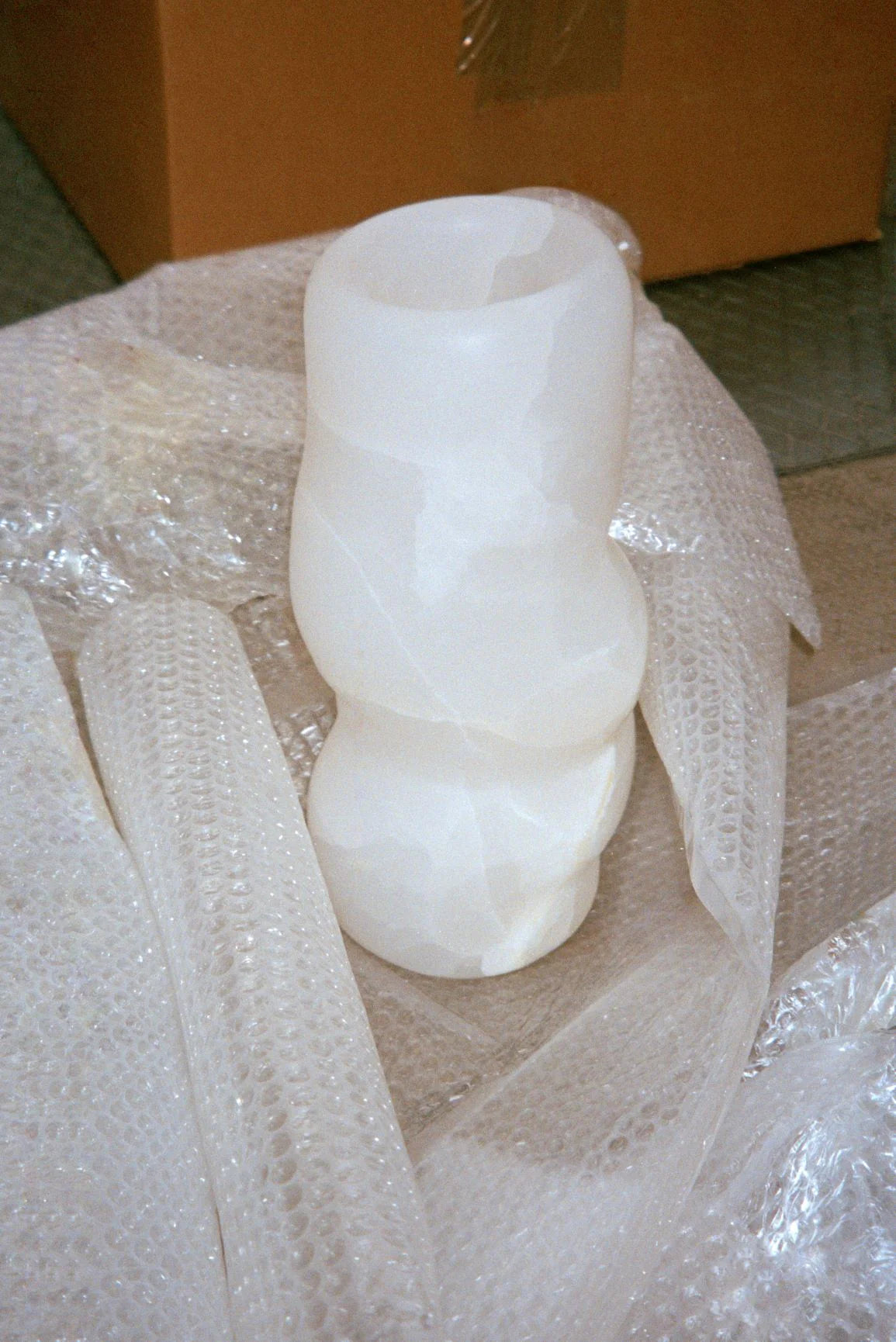 FATROLL White Onyx Vase in Marble — side angle with bubble wrap packaging