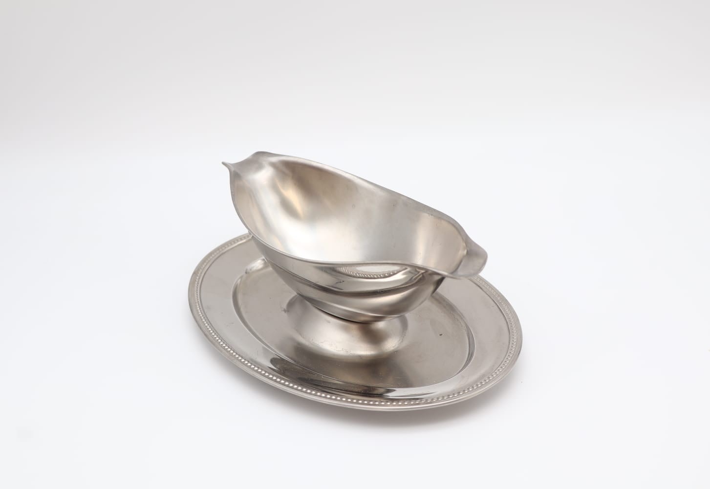 Vintage Guy Degrenne Stainless Steel Gravy Boat with Fixed Saucer (c. 1970) — side angle