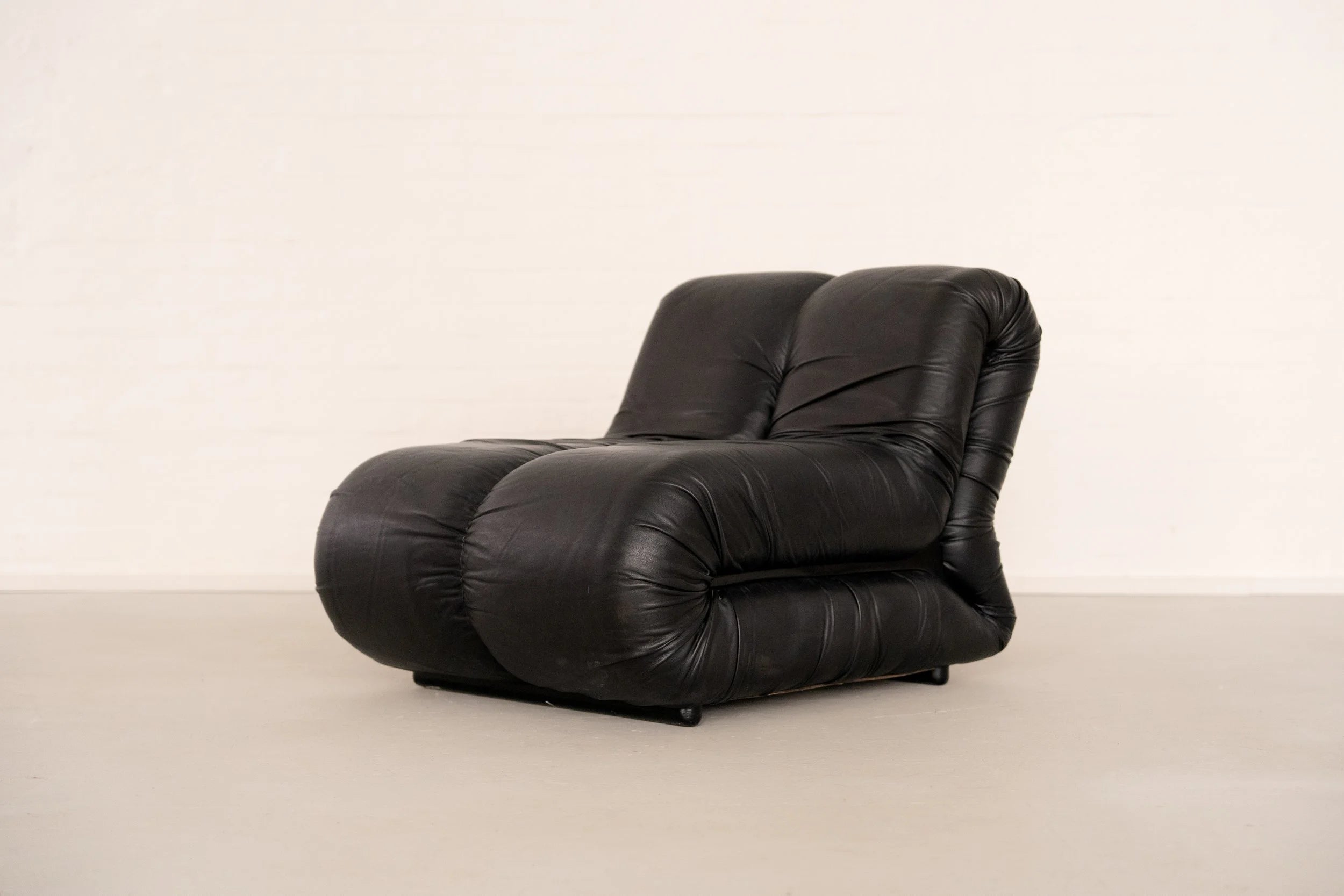 Pagru Lounge Chair by Claudio Vagnoni for 1P — angled view of black leather upholstery