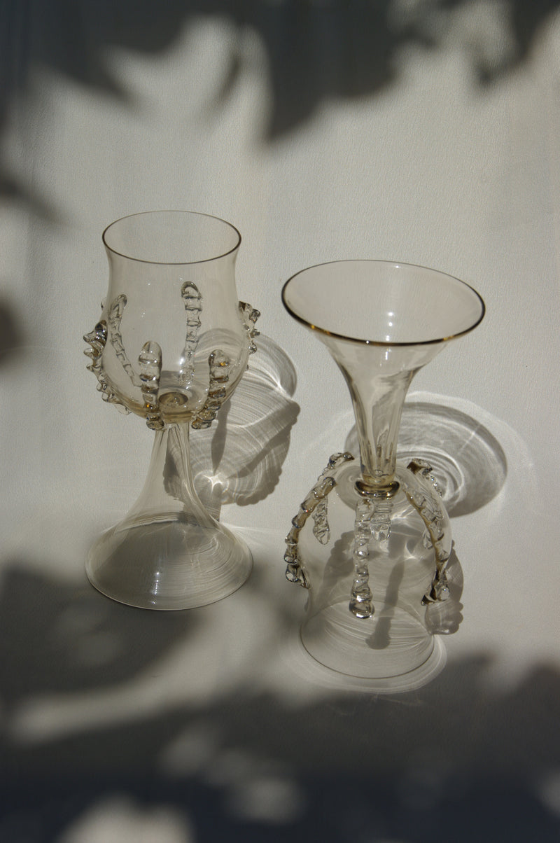 Pair of mouthblown glass wine goblets with decorative ribbed stems