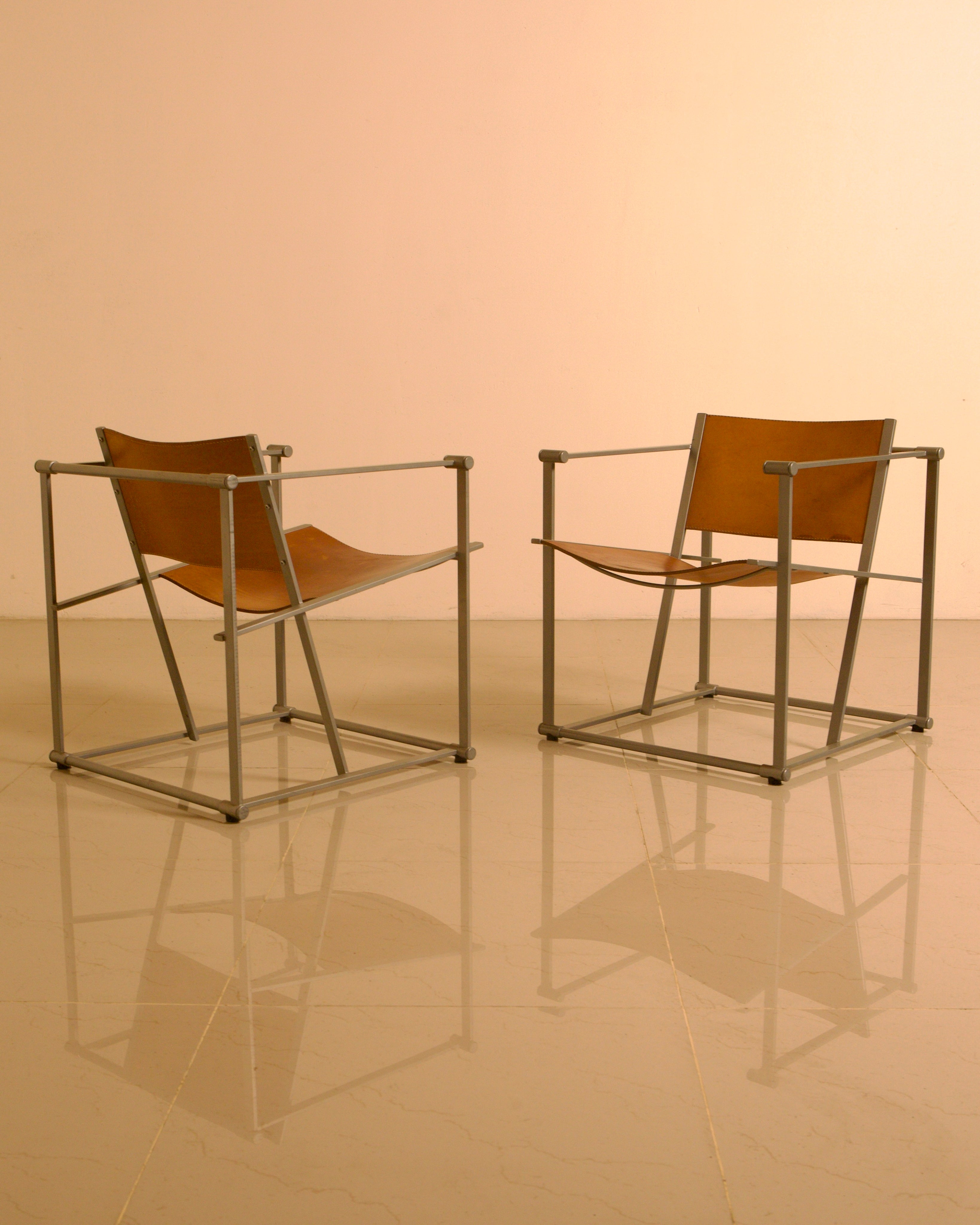 Pair of "FM62" Armchairs by Radboud van Beekum for Pastoe, 1980s — angled view highlighting leather seat and metal frame