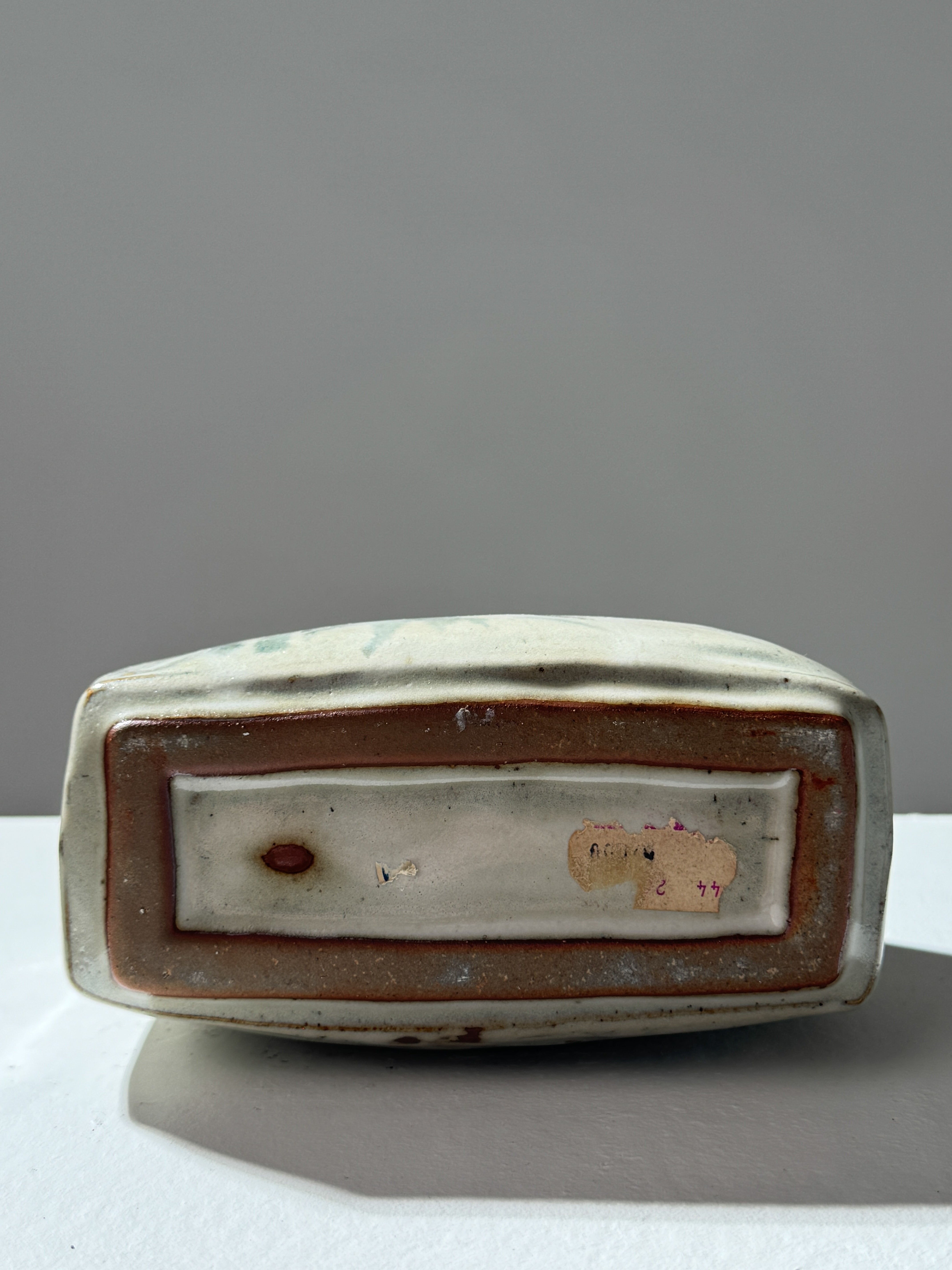 Bottom view of ceramic vase showing maker's mark and glazed base