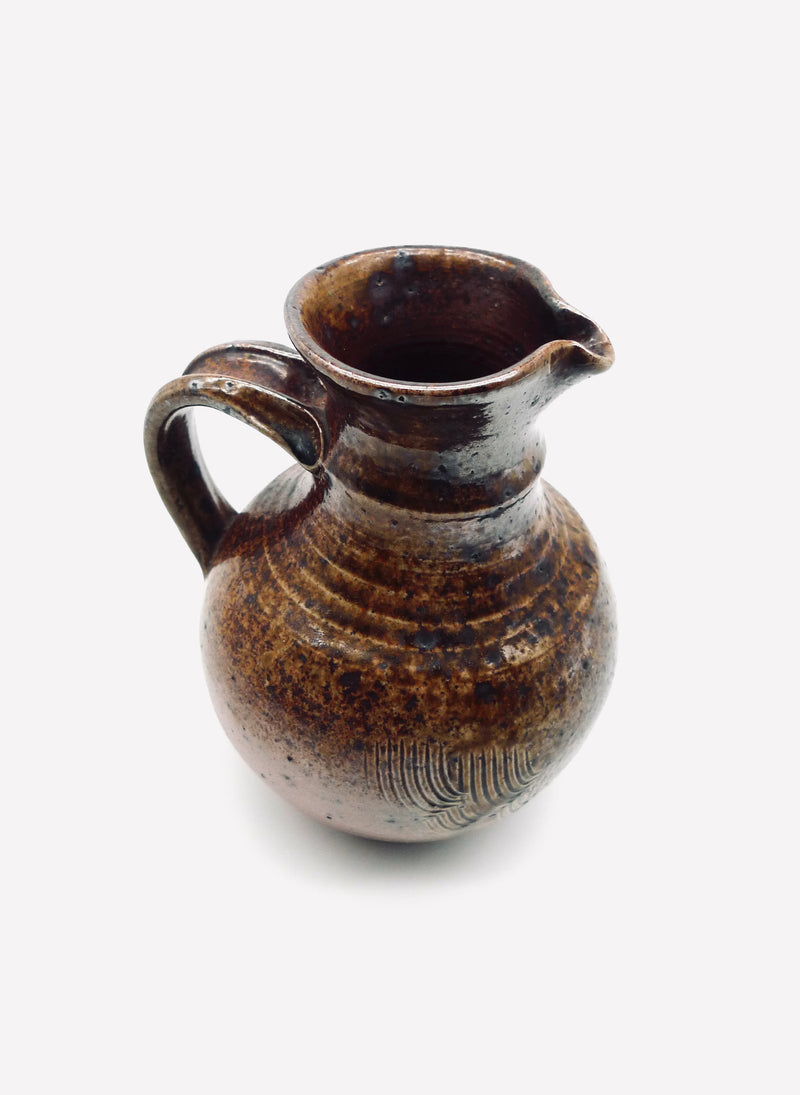 Brown glazed French stoneware pitcher with ribbed texture detail