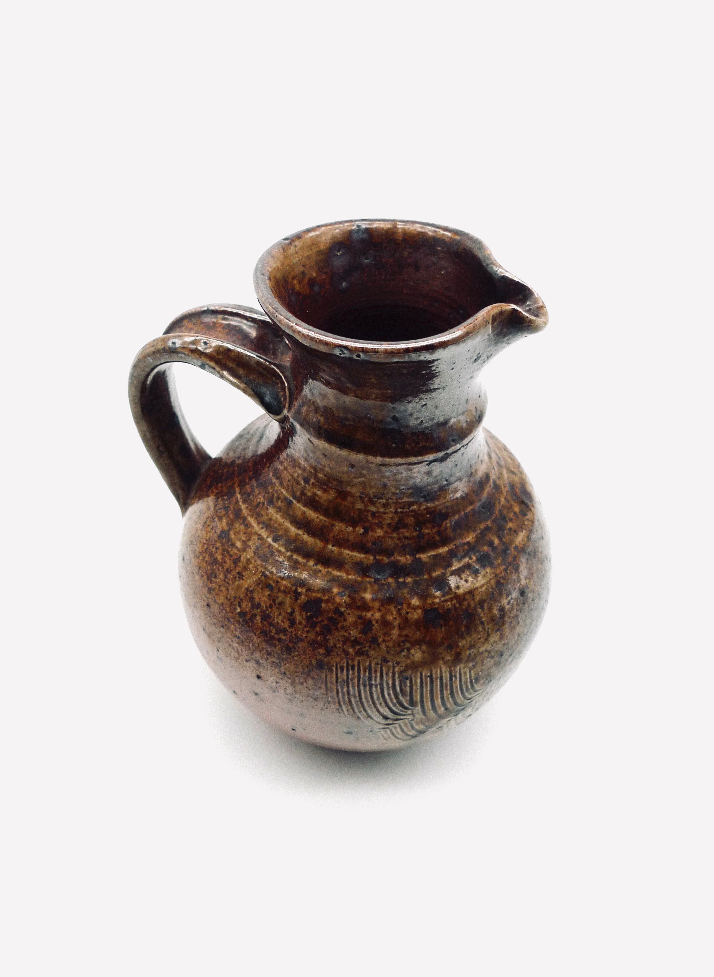 Brown glazed French stoneware pitcher with ribbed texture detail