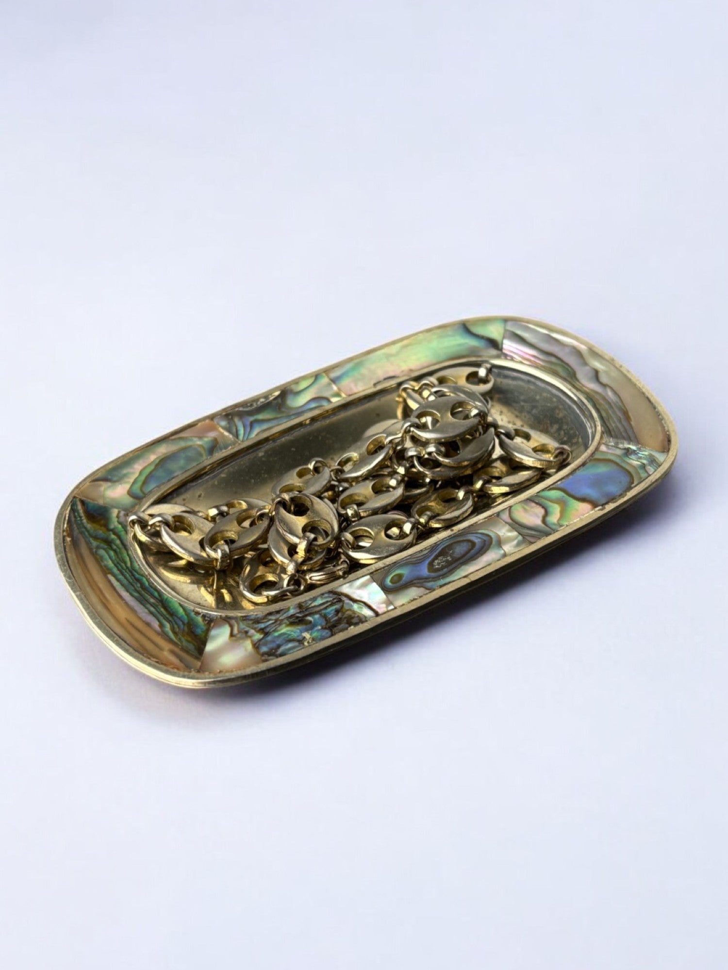 Abalone shell & alpaca tray, Mexico, circa 1970 — angled view with jewelry on tray
