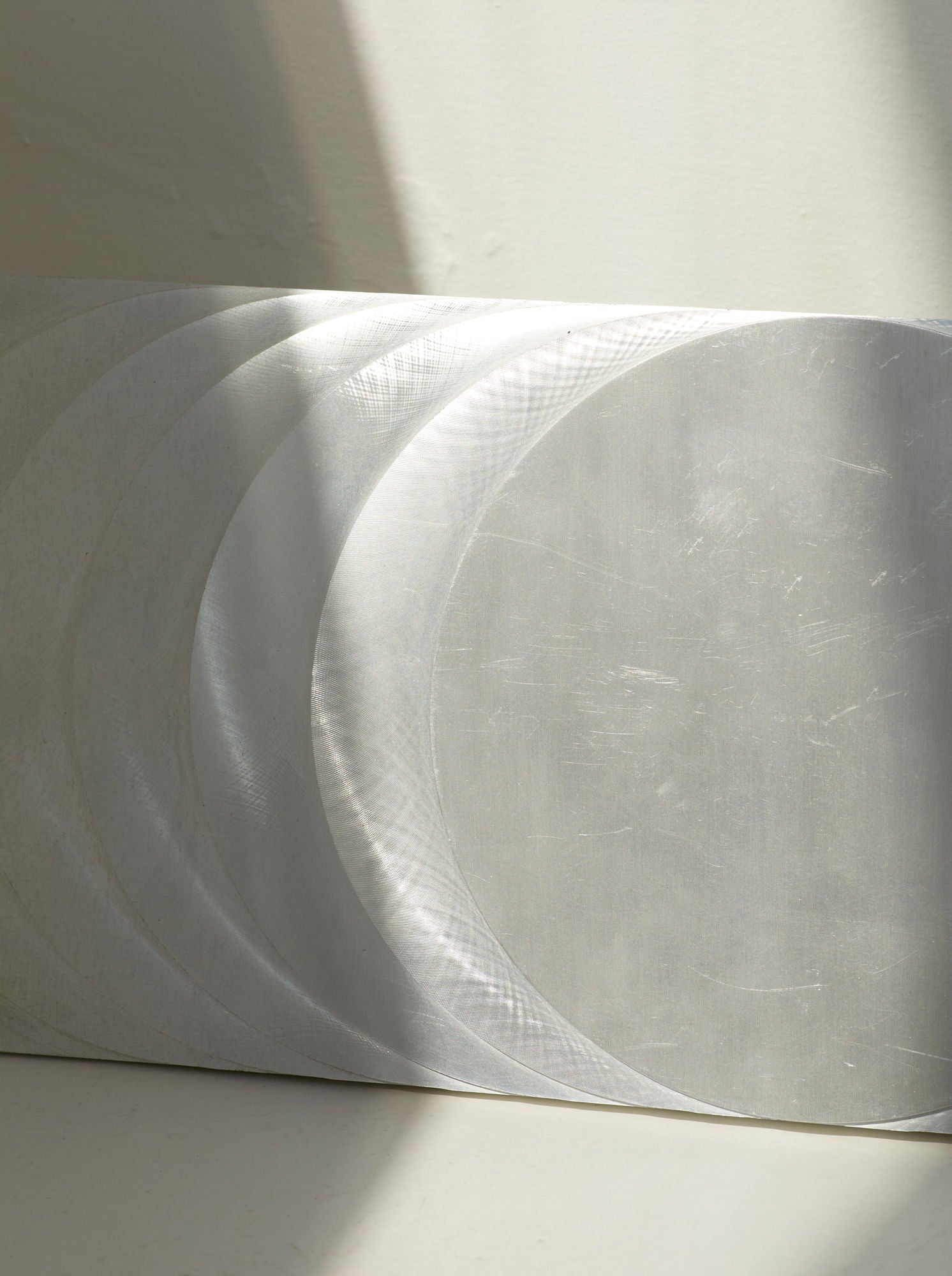 ‘The Sun’s Path' Steel Wall Sculpture By Anonymous French Artist Circa 1970 — close-up of brushed steel surface with light re