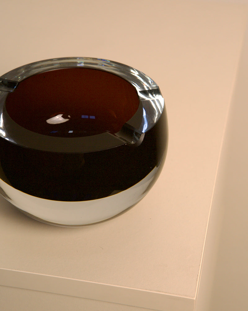 Italian dark brown Murano glass ashtray showing curved interior detail