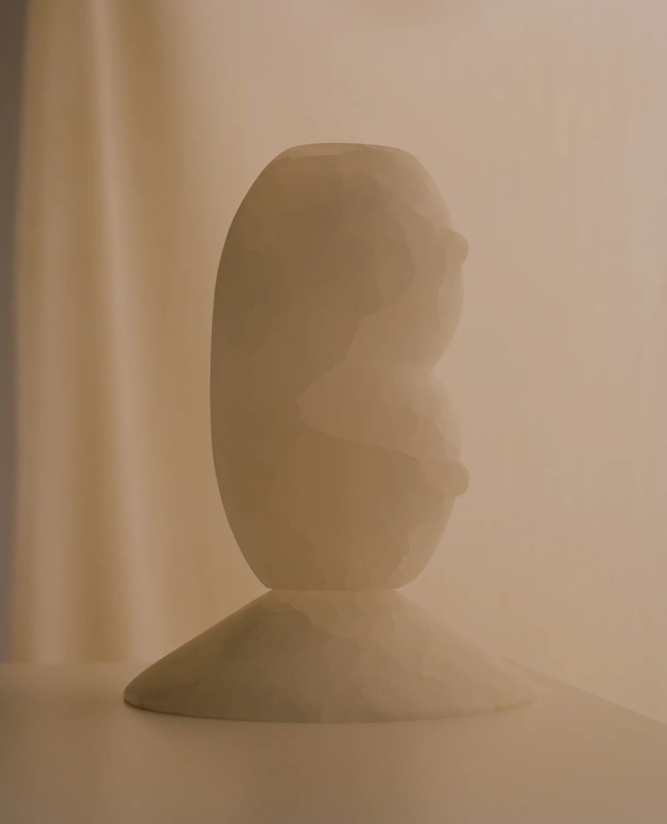 CLELIA White Onyx Sculptural Vase — side angle with soft lighting