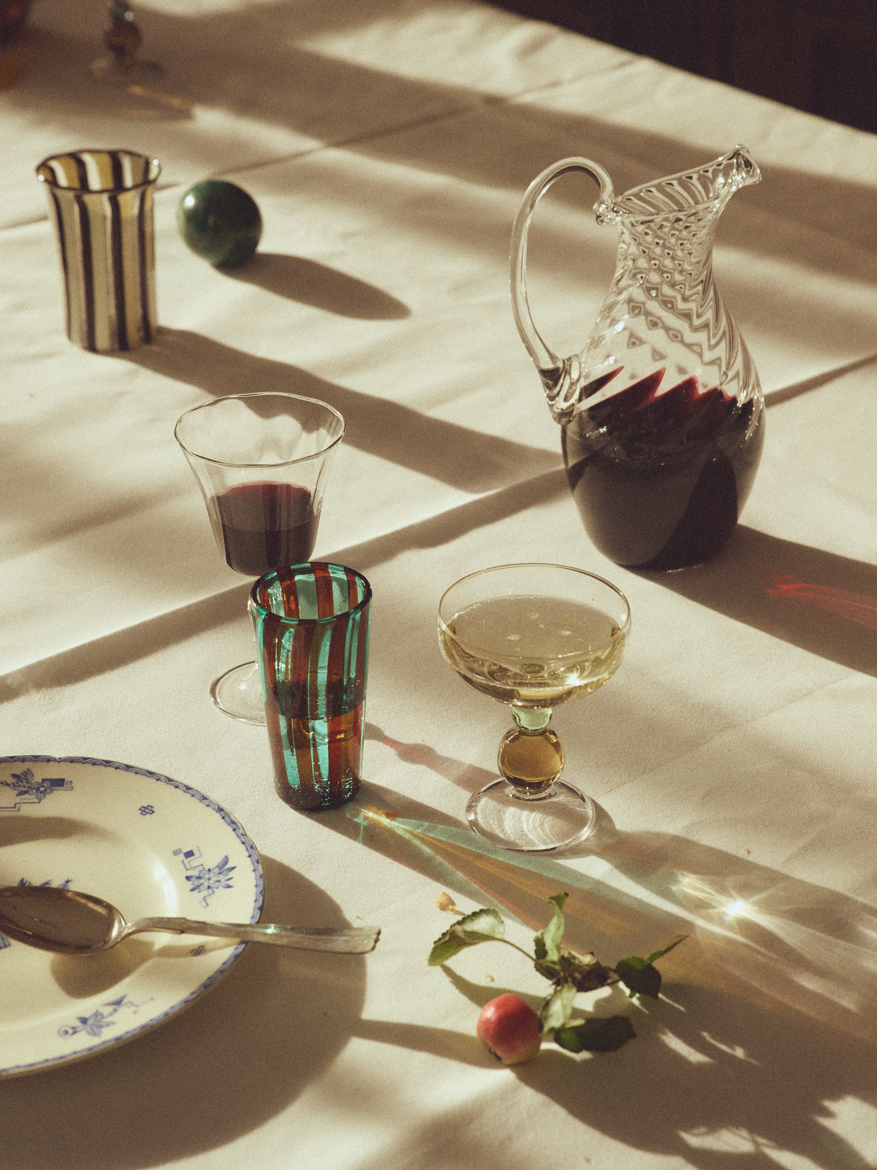 Alban Wine Glass Large - Set of Four — back view with colorful glassware on table