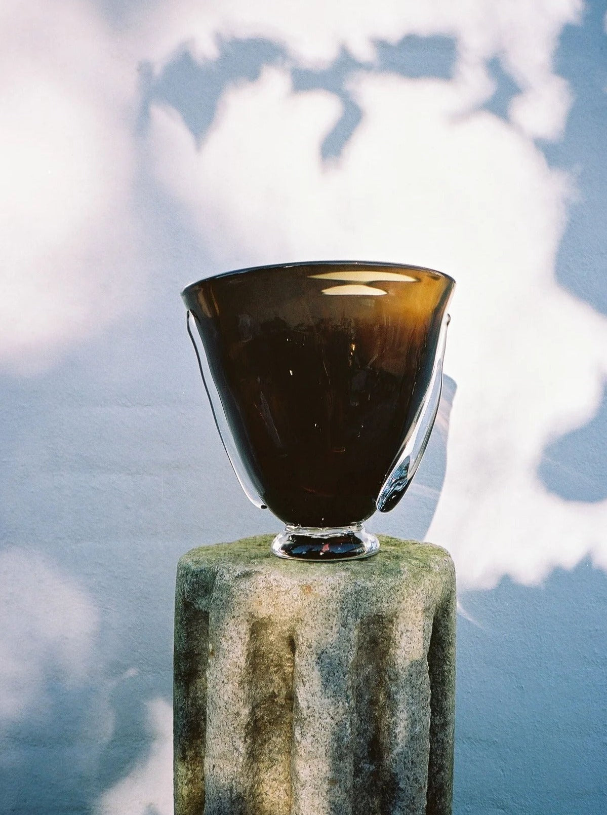 Mouth Blown Karl Vase — brown glass vase on stone pedestal