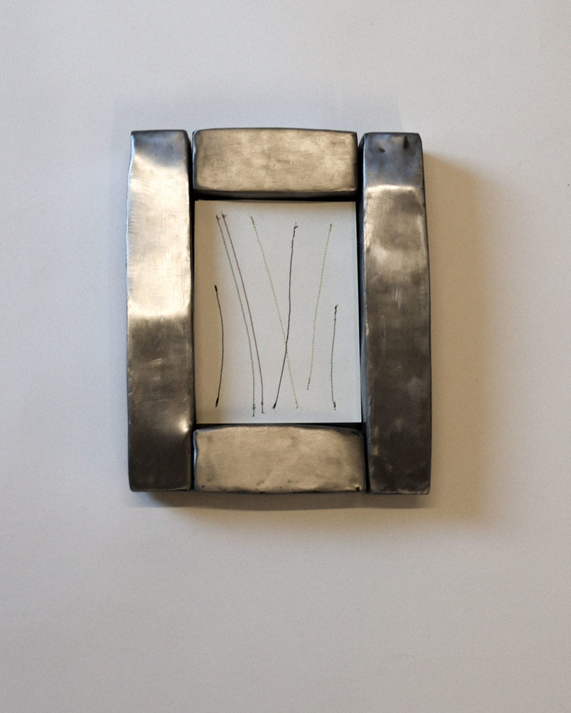 Hammered steel frame with white matting displaying simple line drawing