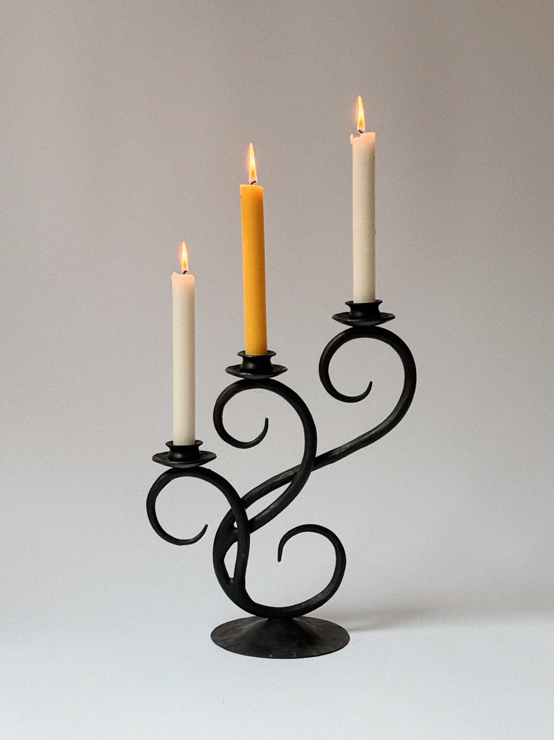 Wrought Iron 3 Arm Swirl Candelabra — close-up of black metal with candles