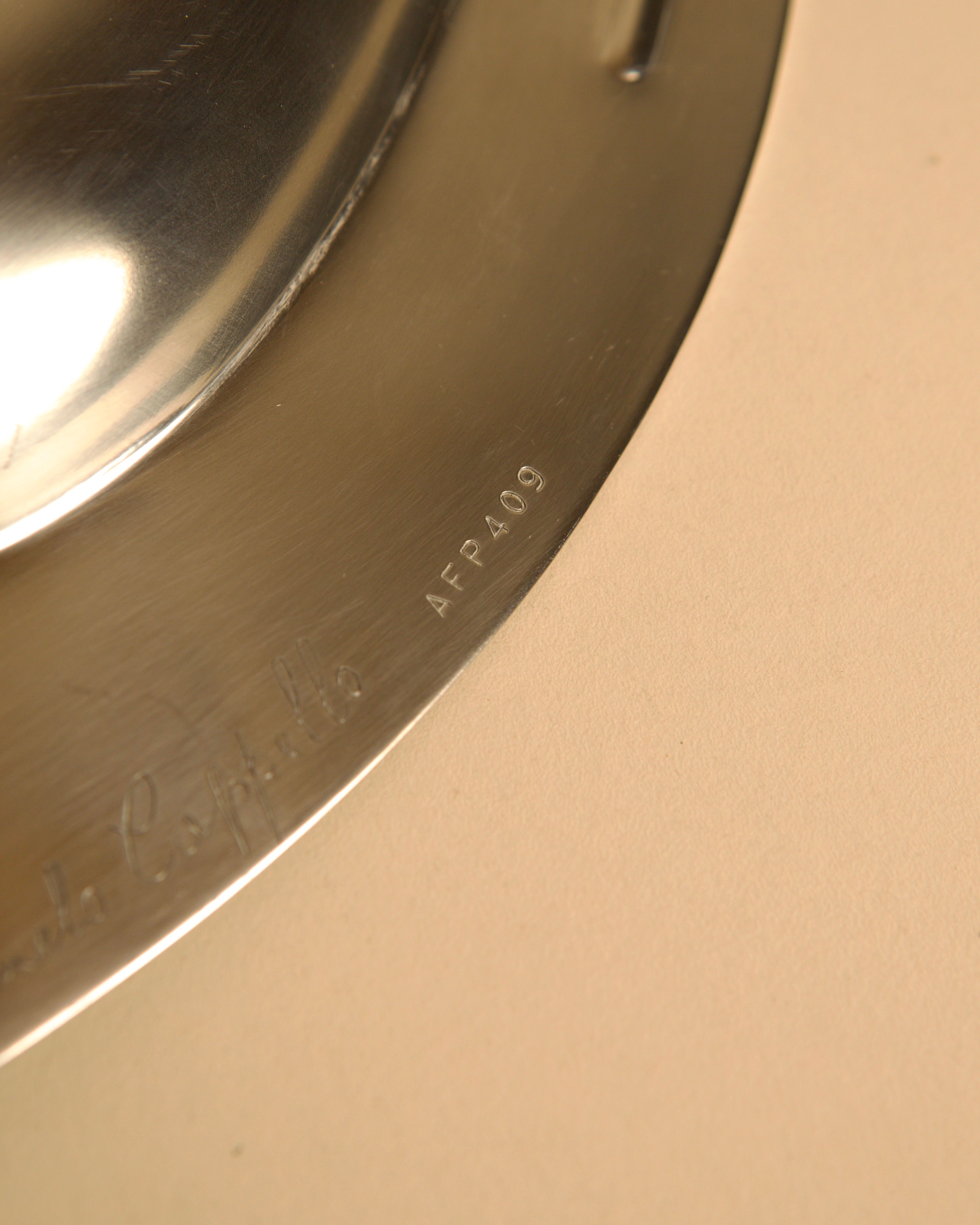 Large metal storage compartment 'Forma Orizzontale Circolare' by Carmelo Cappello — close-up of polished metal surface detail