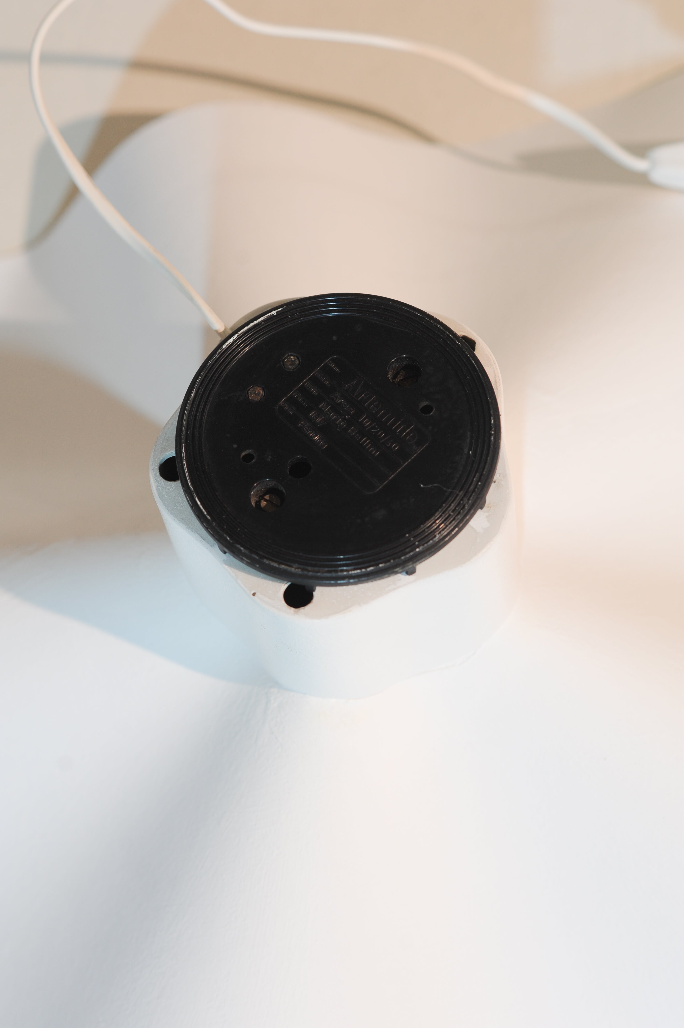 Mario Bellini Area Lamp, Italy 1974 — top view of black base on white surface
